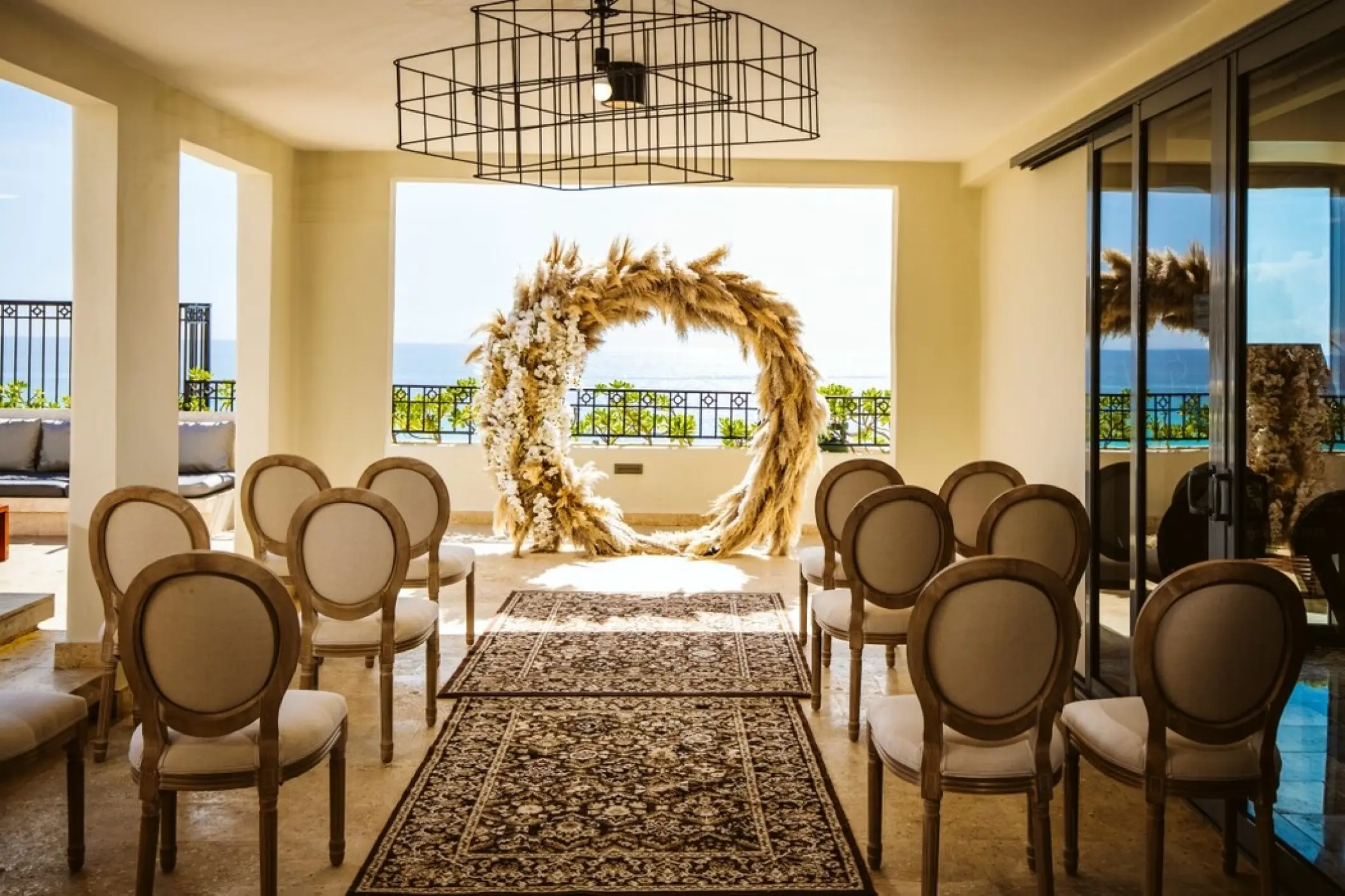 Presidential Suite terrace wedding ceremony with pampas grass arch at Fiesta Americana Condesa, Cancun