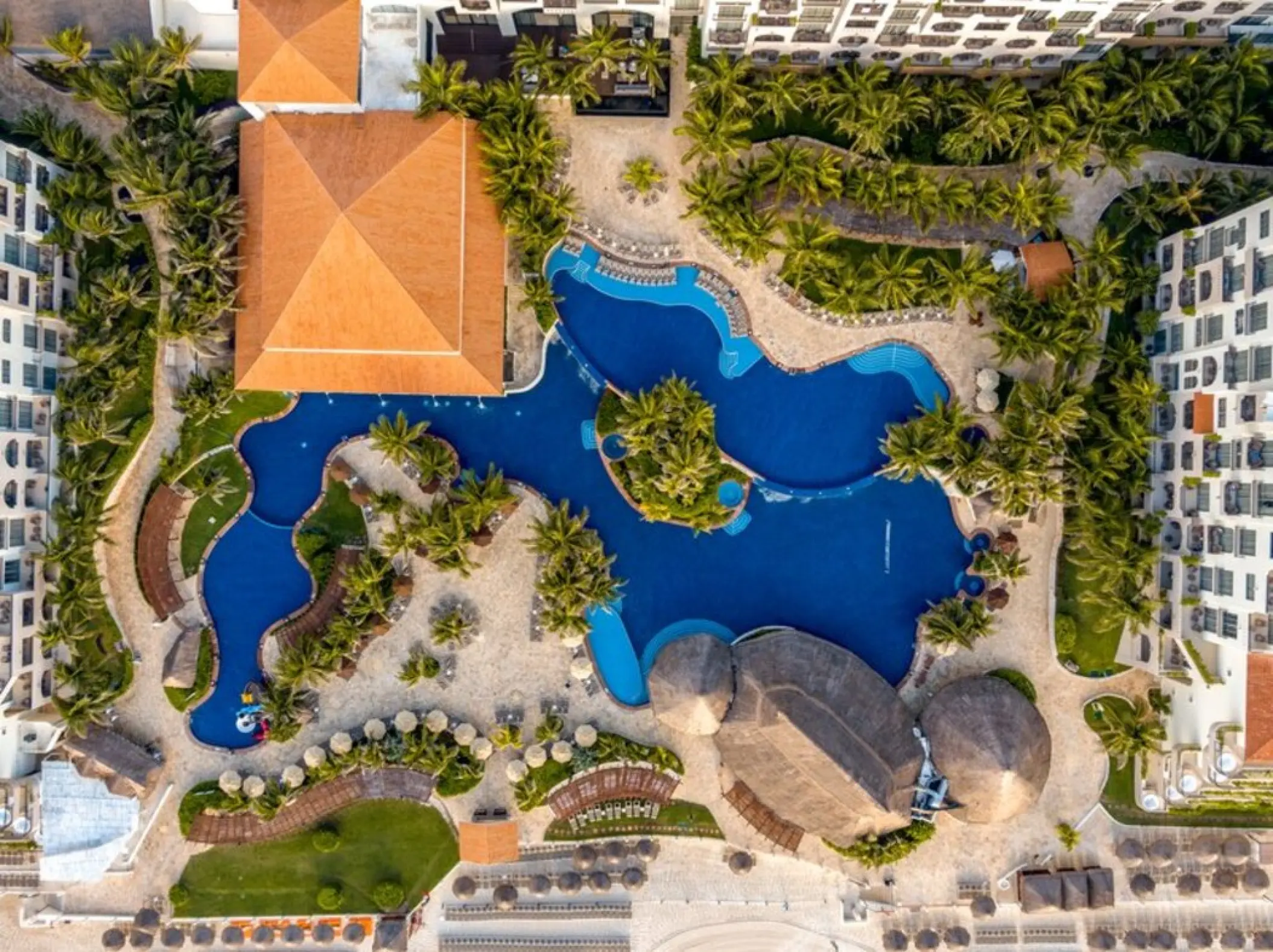 Aerial view of the winding swimming pools and tropical grounds at Fiesta Americana Condesa, Cancun