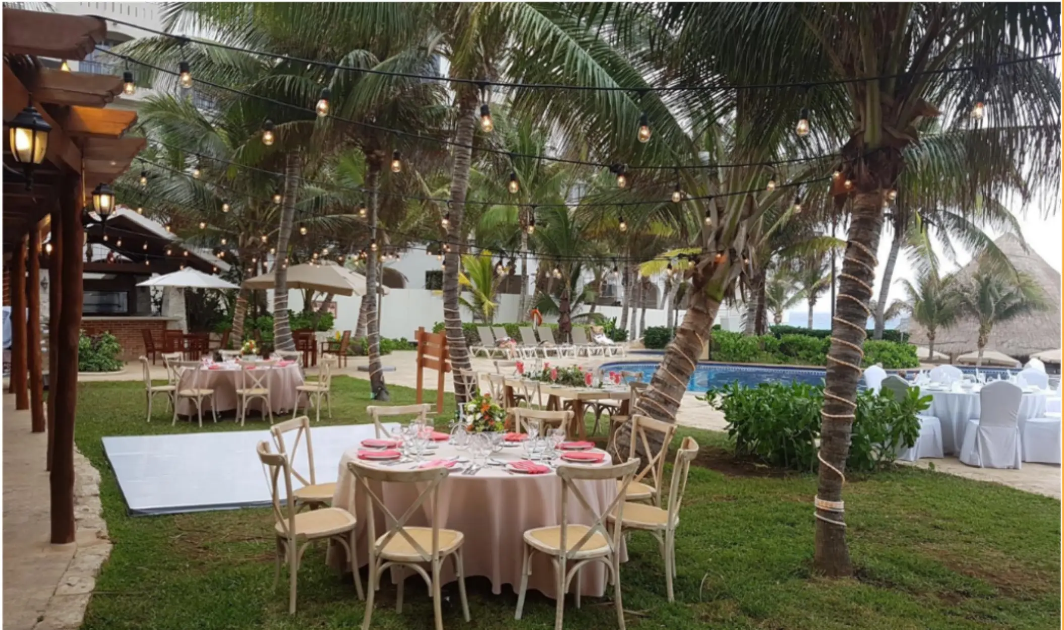 Sun Garden wedding reception with string lights and white dance floor at Fiesta Americana Condesa, Cancun