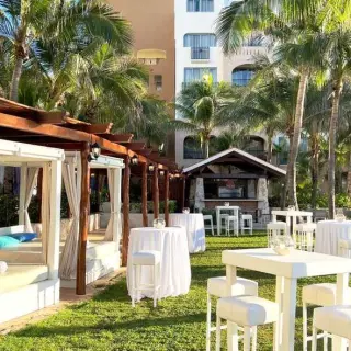 Sun Garden wedding reception with cabanas and high-top tables at Fiesta Americana Condesa, Cancun