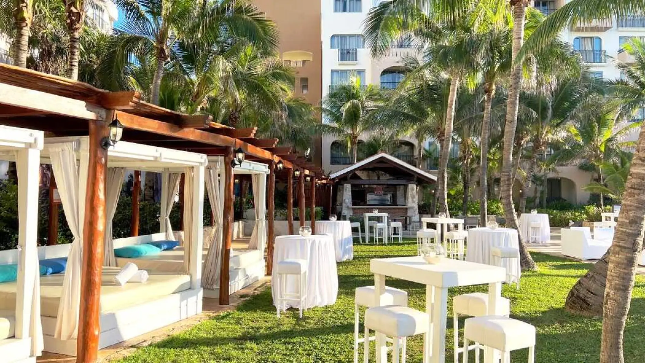 Sun Garden wedding reception with cabanas and high-top tables at Fiesta Americana Condesa, Cancun