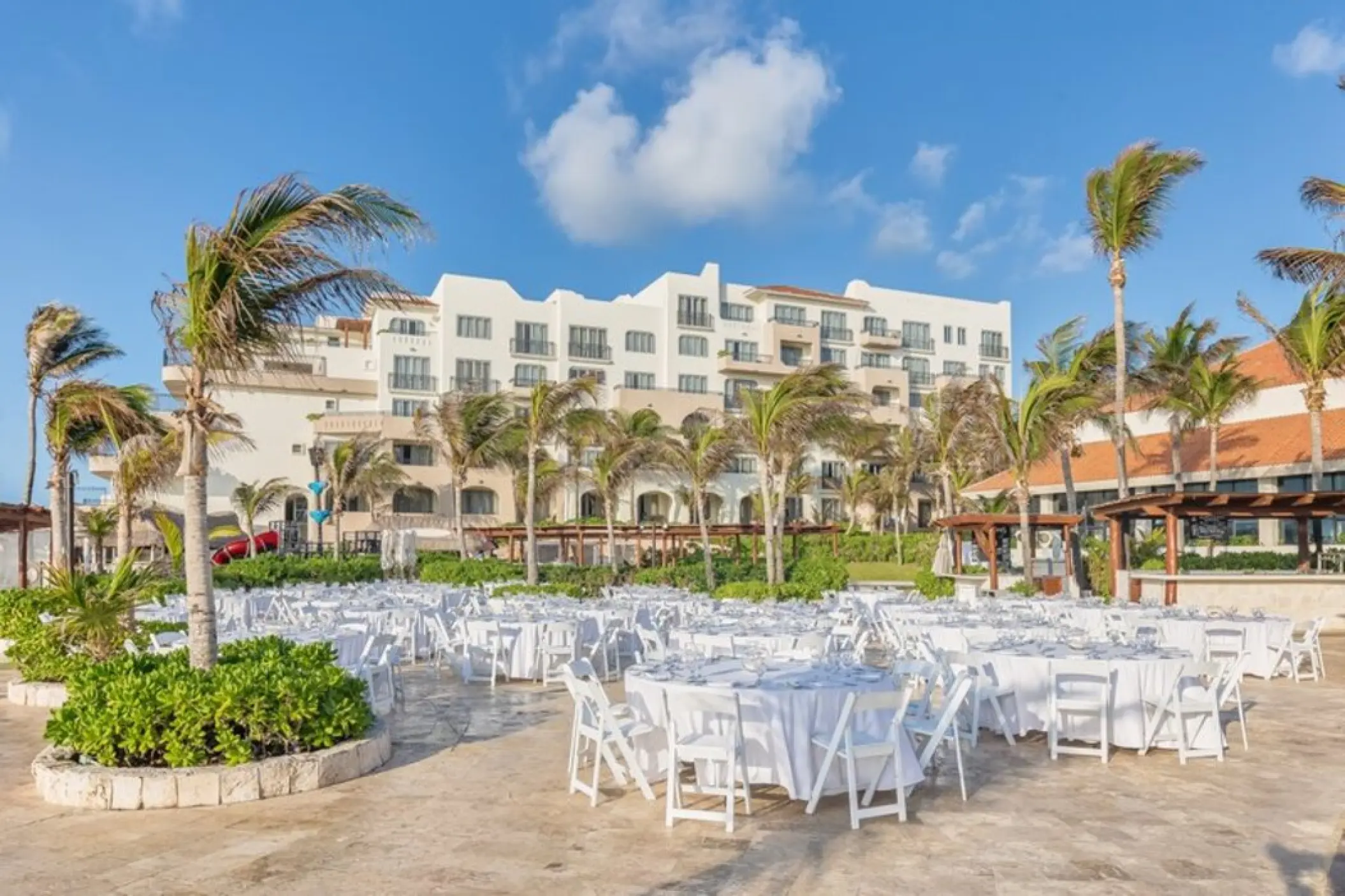 Terraza Condesa wedding reception with white round tables at Fiesta Americana Condesa, Cancun