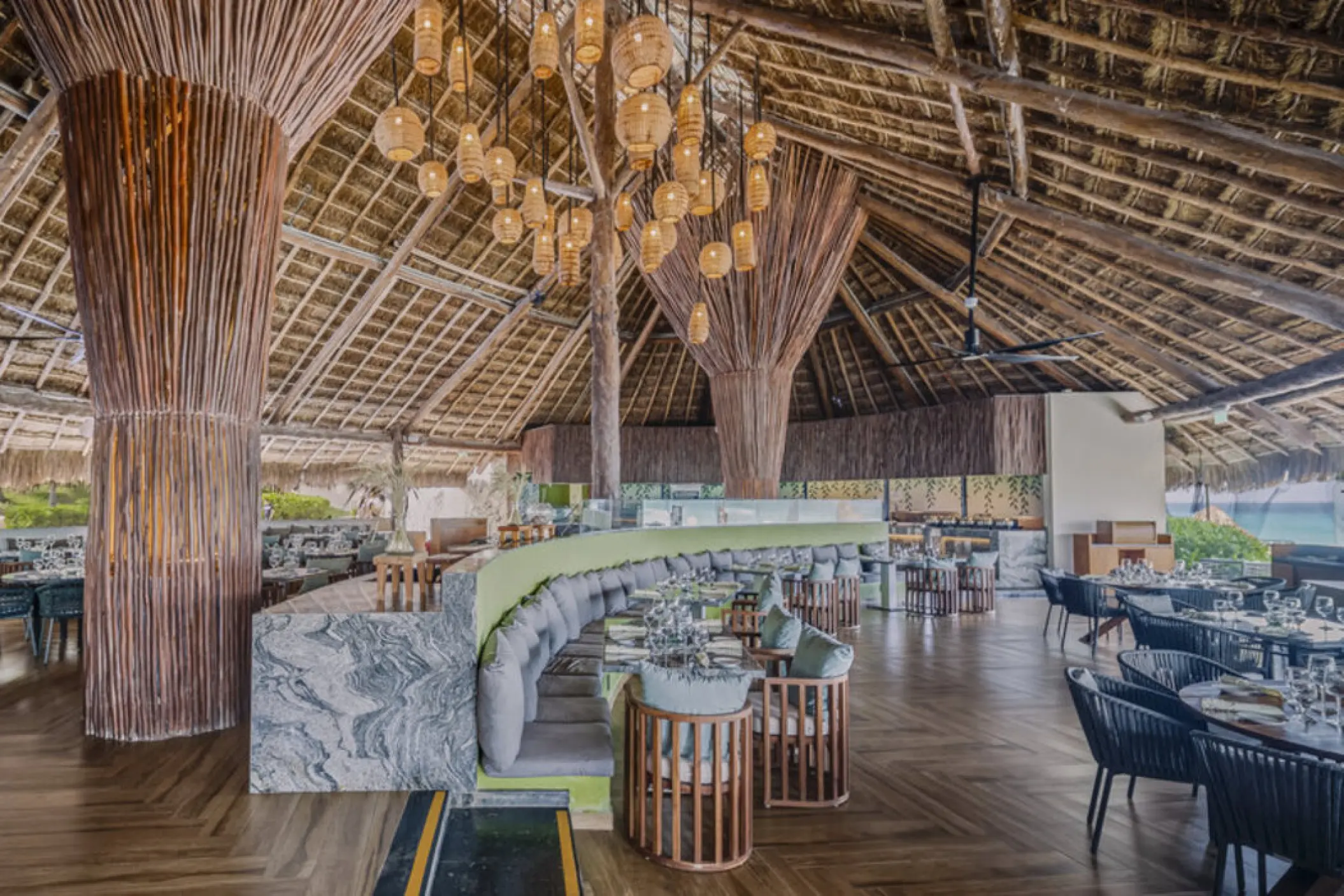 Kambu restaurant with thatched palapa roof and wicker lighting at Fiesta Americana Condesa, Cancun
