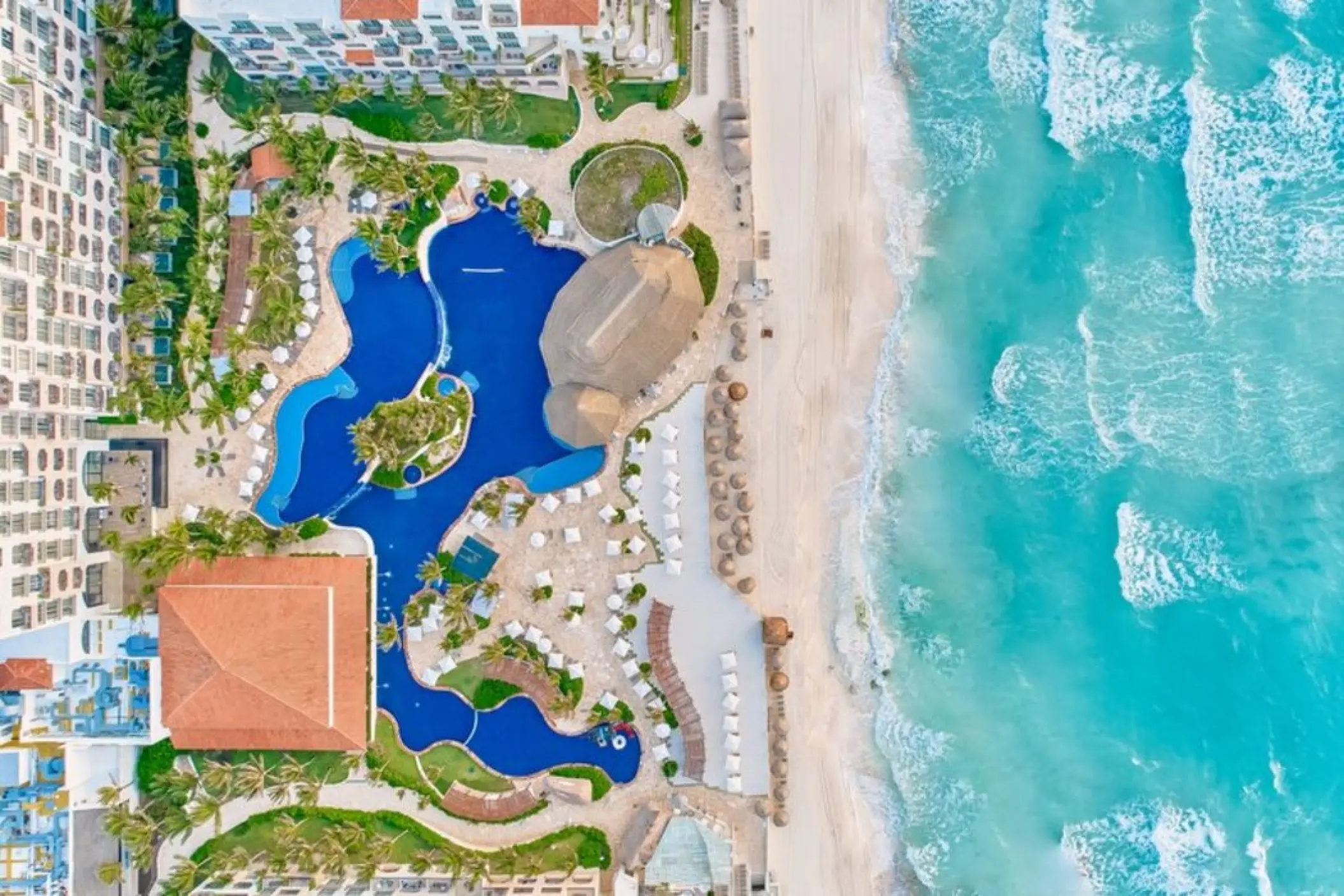 Aerial view of the pools, beachfront, and ocean at Fiesta Americana Condesa, Cancun