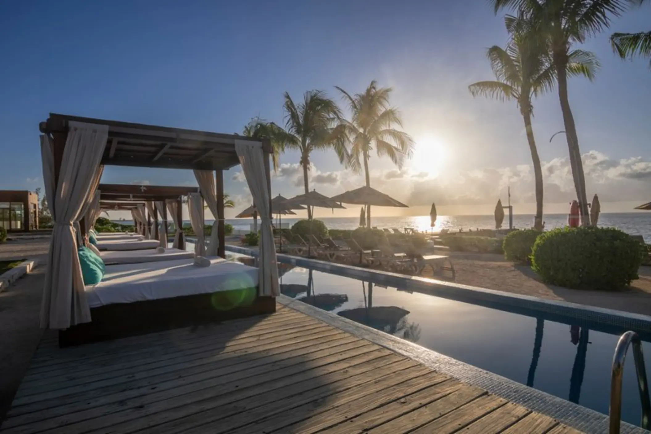 Poolside cabanas at sunset at Fiesta Americana Cozumel