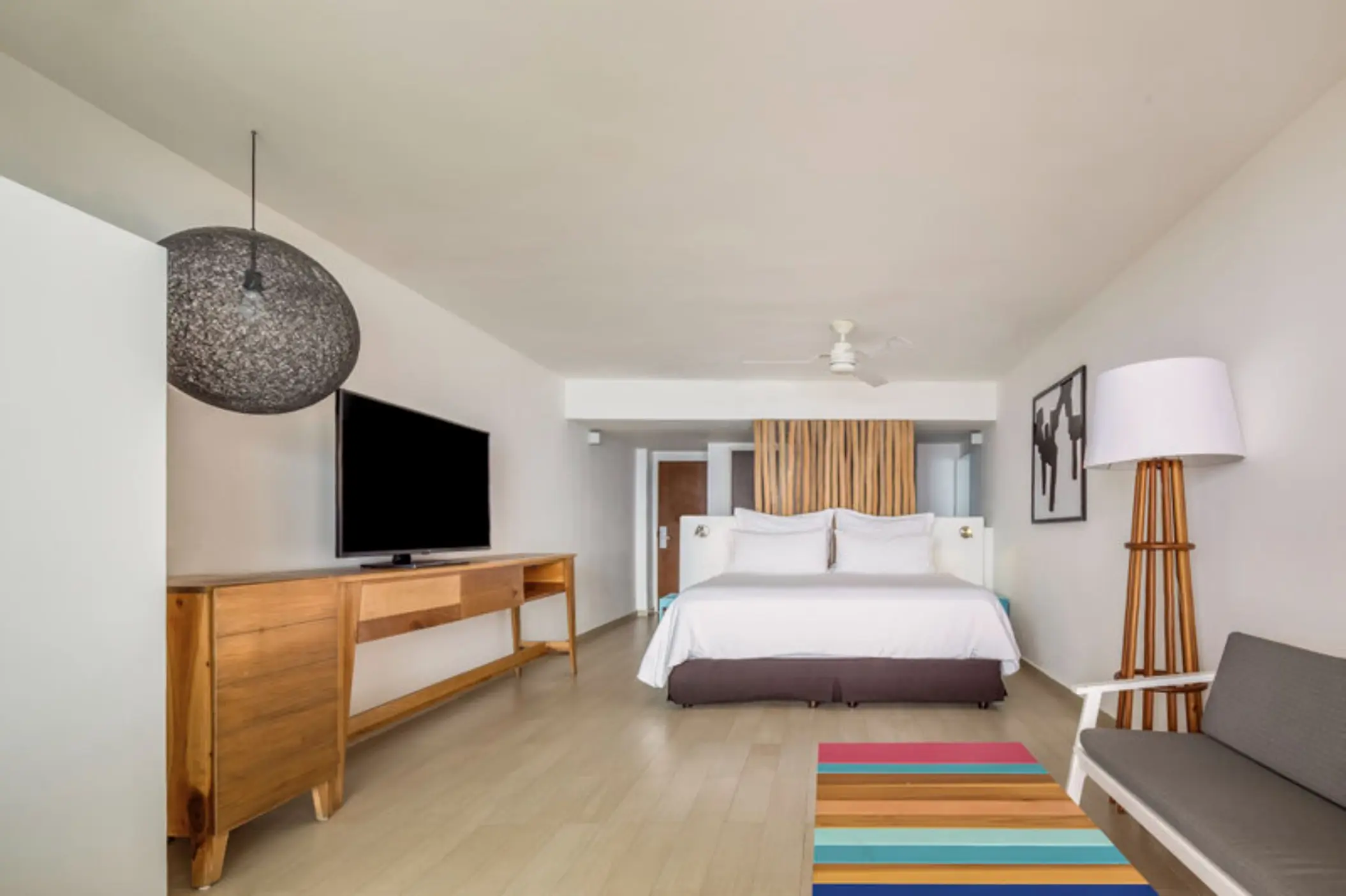 Deluxe King Suite with wooden accents and modern décor at Fiesta Americana Cozumel