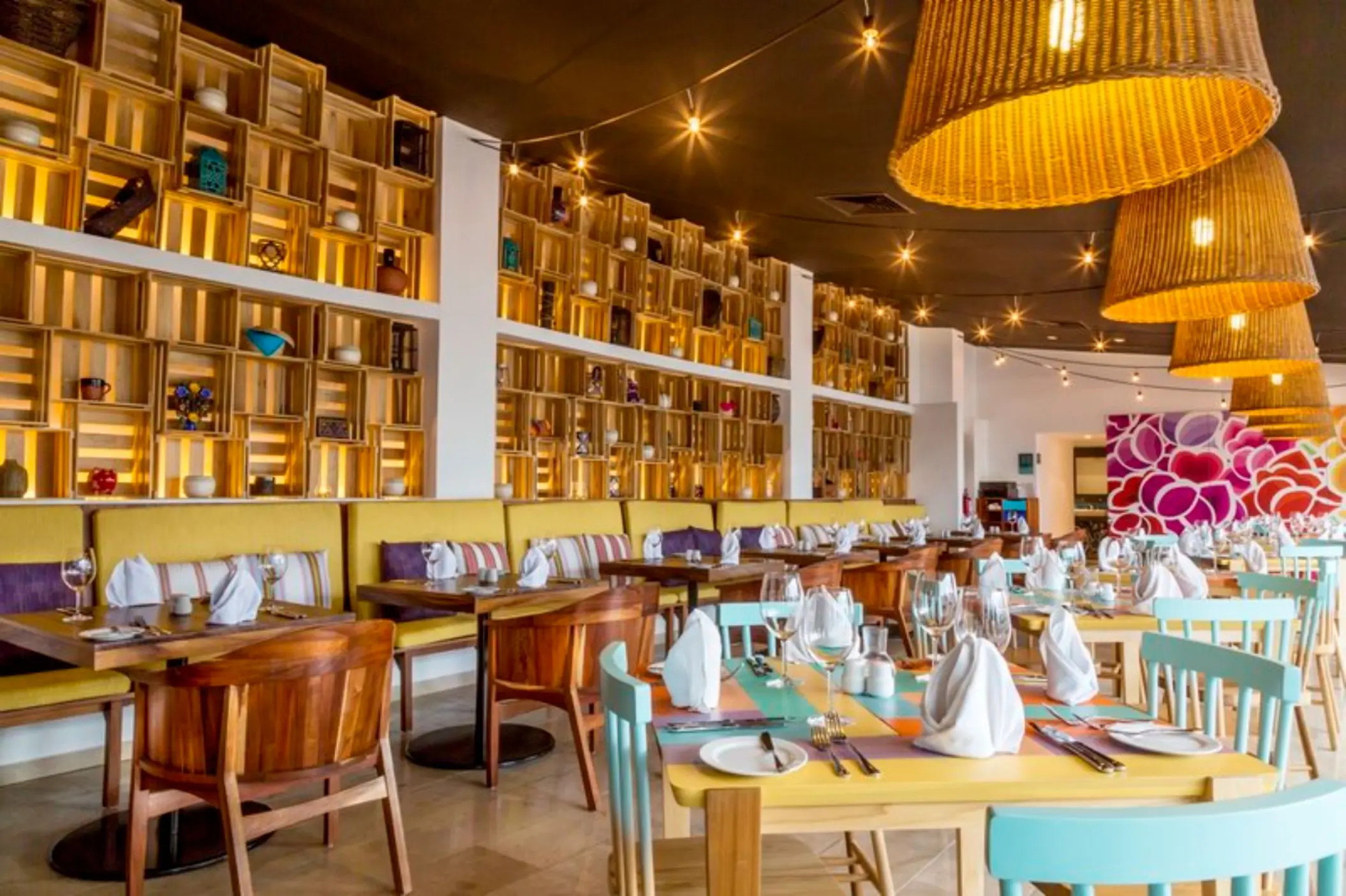 El Mexicano restaurant dining area with wicker pendant lights at Fiesta Americana Cozumel