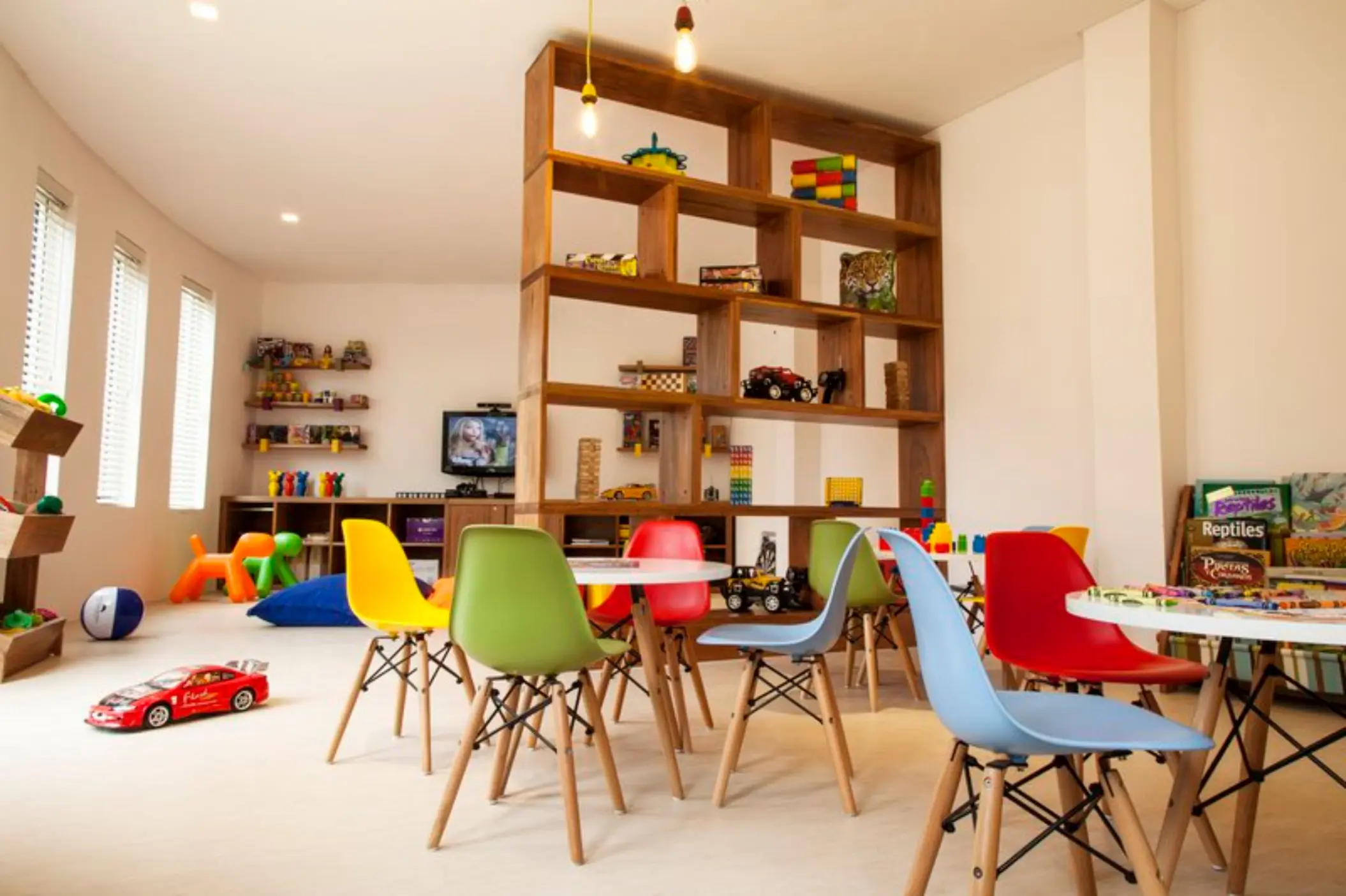Fiesta Americana Cozumel kids club with colorful chairs and wooden shelving, Cozumel