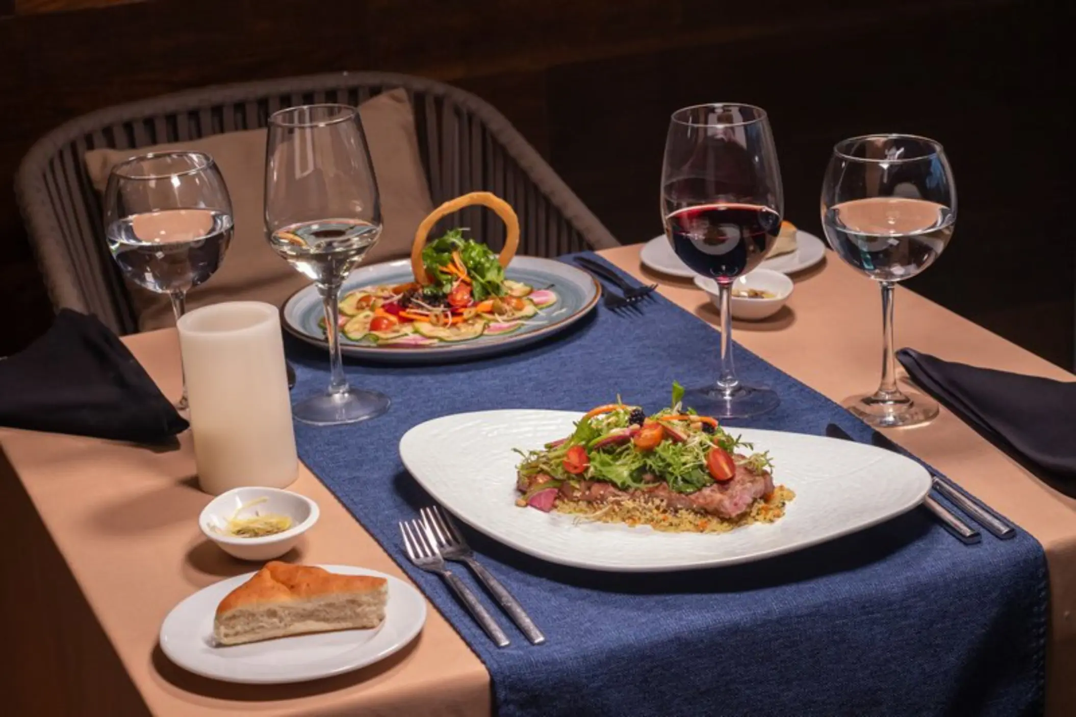 Plated gourmet dinners with red wine at Rosato restaurant in Fiesta Americana Cozumel