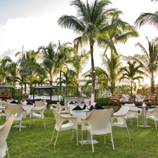 Garden wedding reception with white chairs and palm trees at Fiesta Americana Cozumel