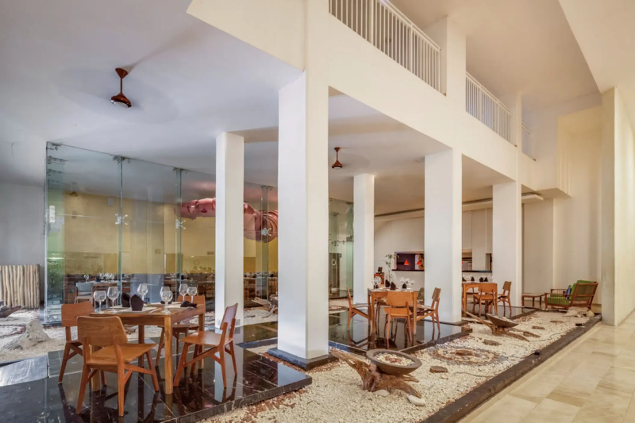 Modern Peninsula restaurant interior with wood furniture and stone decor at Fiesta Americana Cozumel