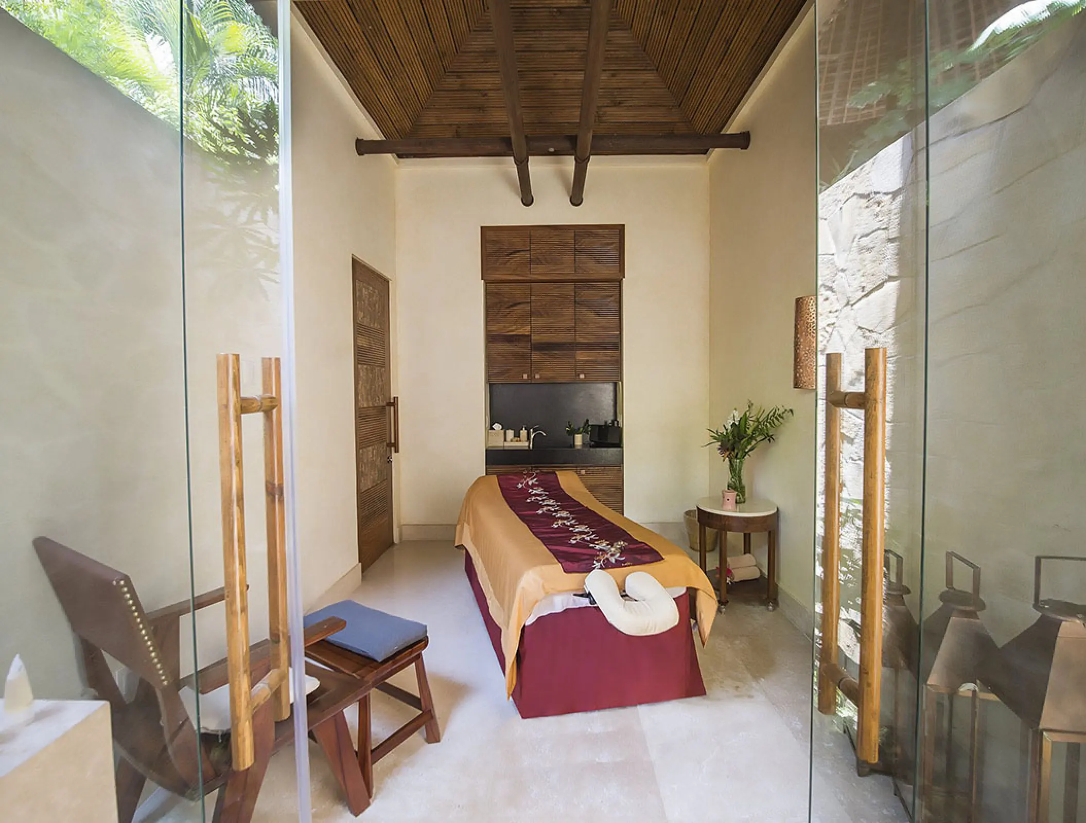 Spa treatment room with a massage table and wooden ceiling at Fiesta Americana Puerto Vallarta