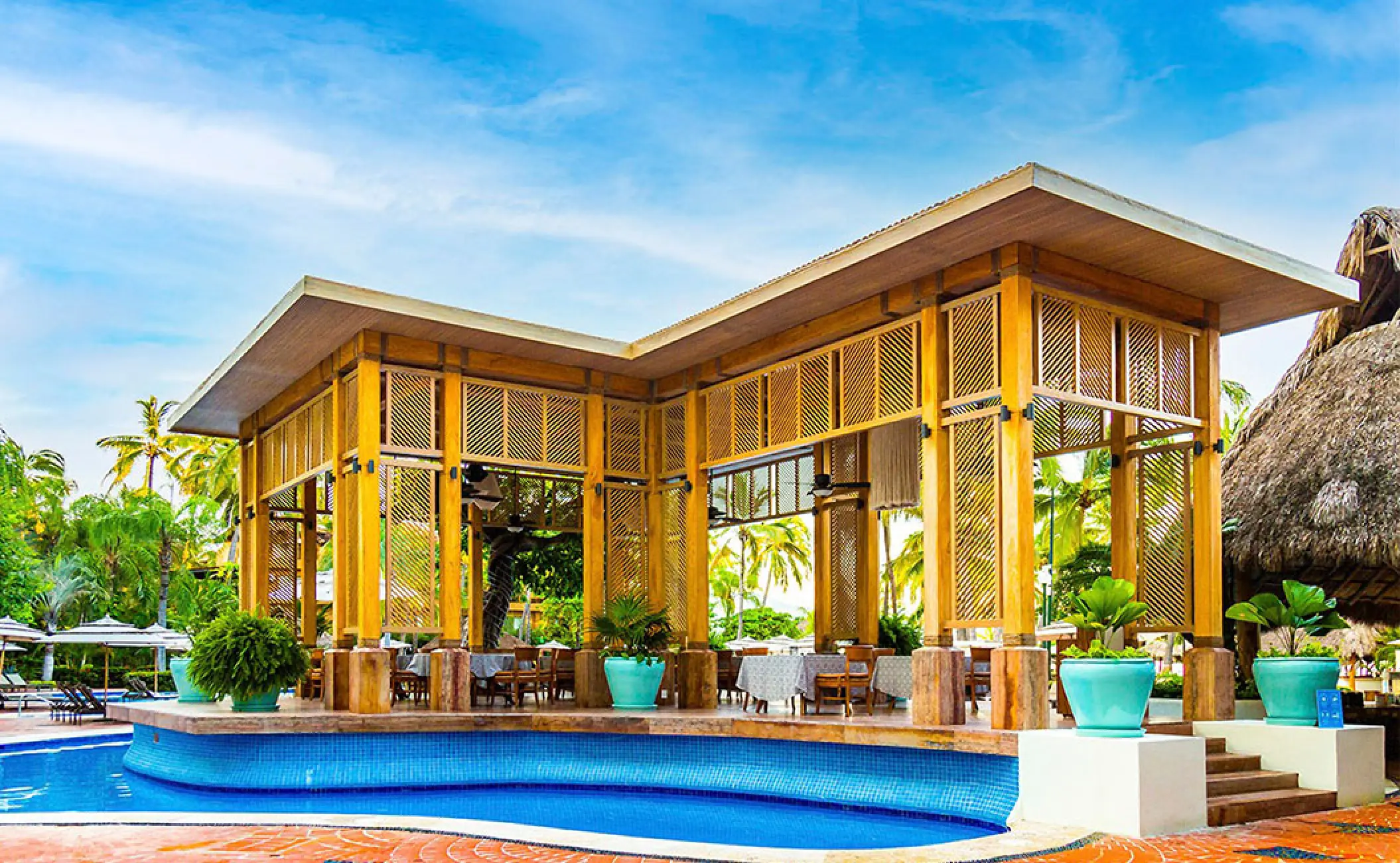 La Isola restaurant with wooden structure by the pool at Fiesta Americana Puerto Vallarta