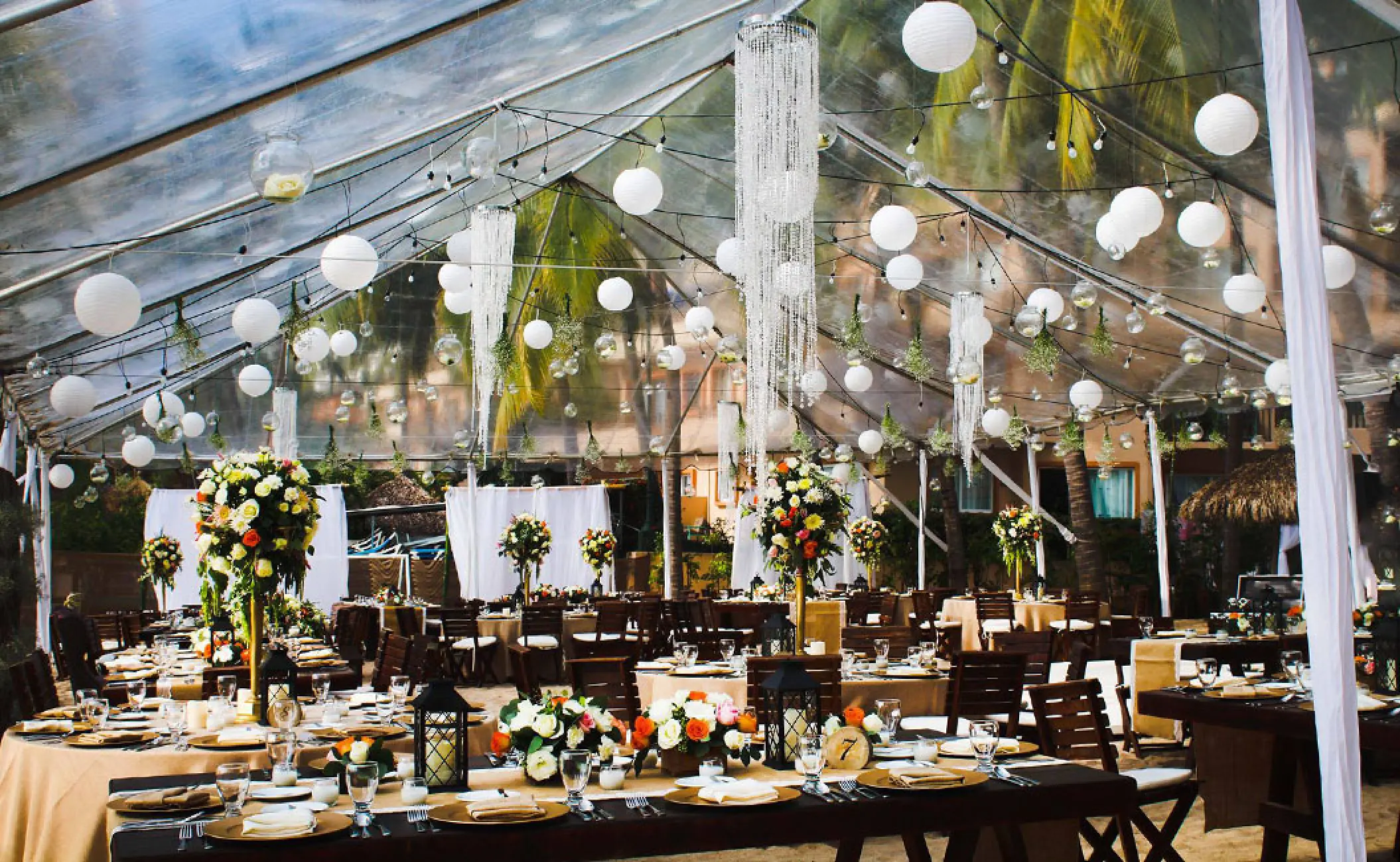 Outdoor wedding reception setup under a transparent tent at Fiesta Americana Puerto Vallarta