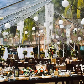 Outdoor wedding reception setup under a transparent tent at Fiesta Americana Puerto Vallarta