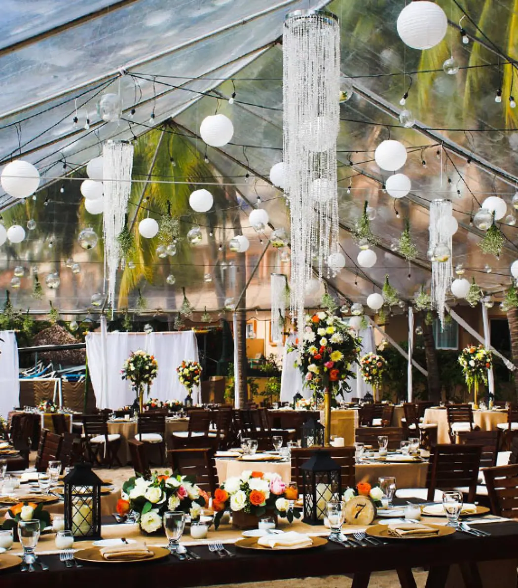 Outdoor wedding reception setup under a transparent tent at Fiesta Americana Puerto Vallarta