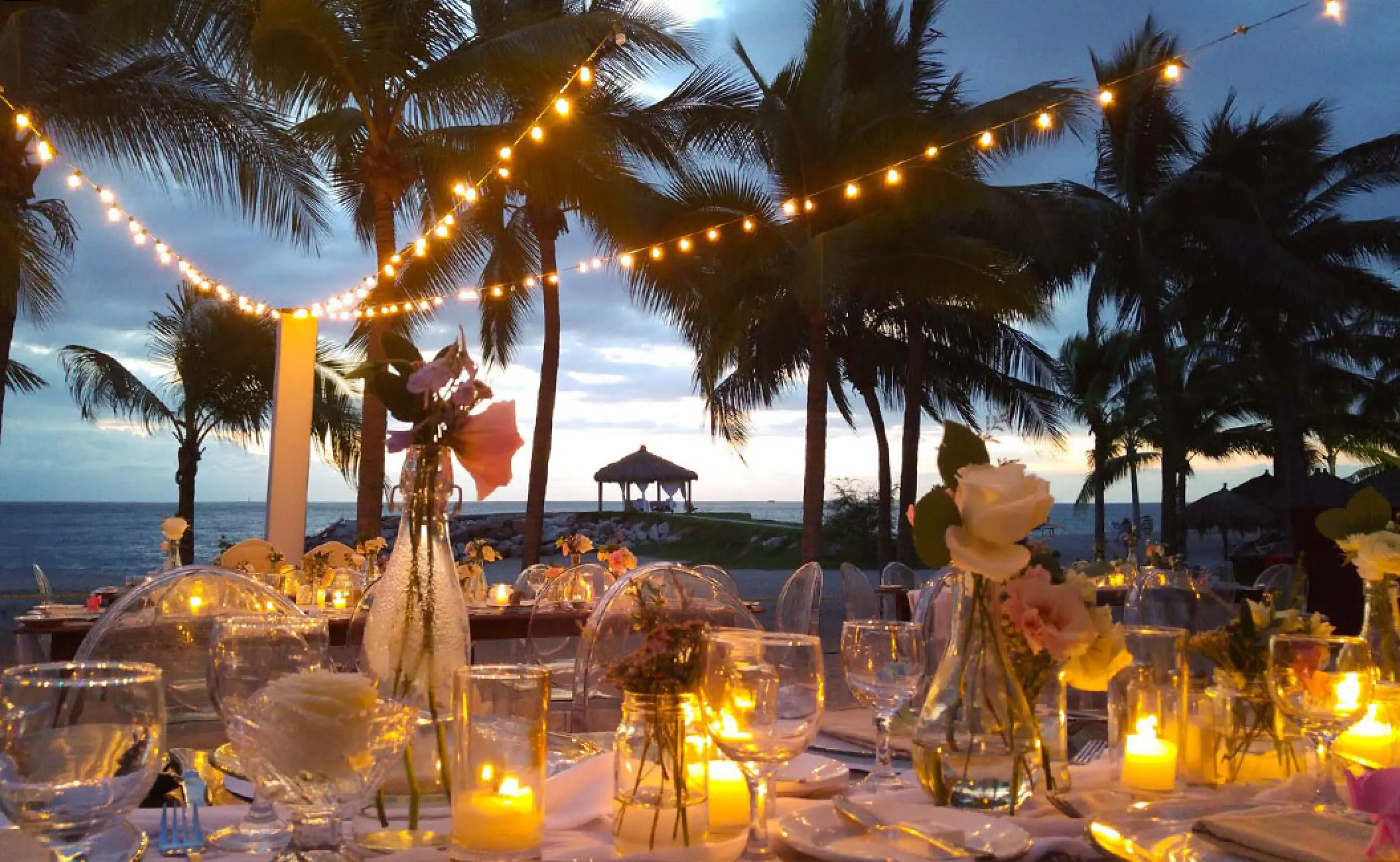 Outdoor wedding reception with string lights and candles at Fiesta Americana Puerto Vallarta
