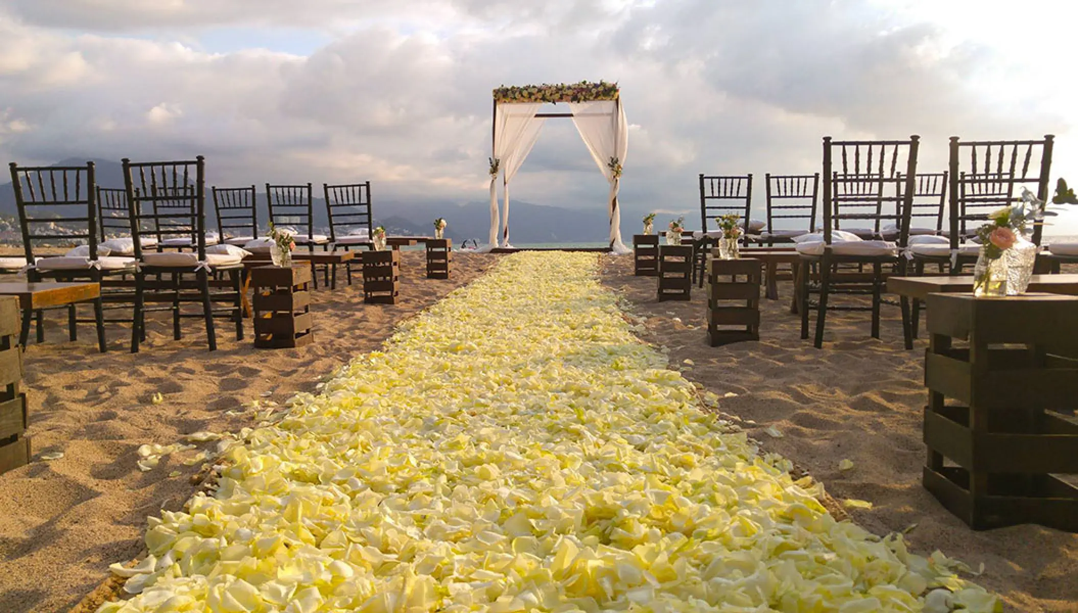 Beach wedding ceremony with yellow flower petal aisle at Fiesta Americana Puerto Vallarta