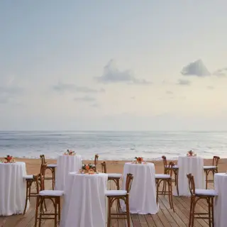 Beachfront wedding reception deck with cocktail tables at Finest Punta Cana