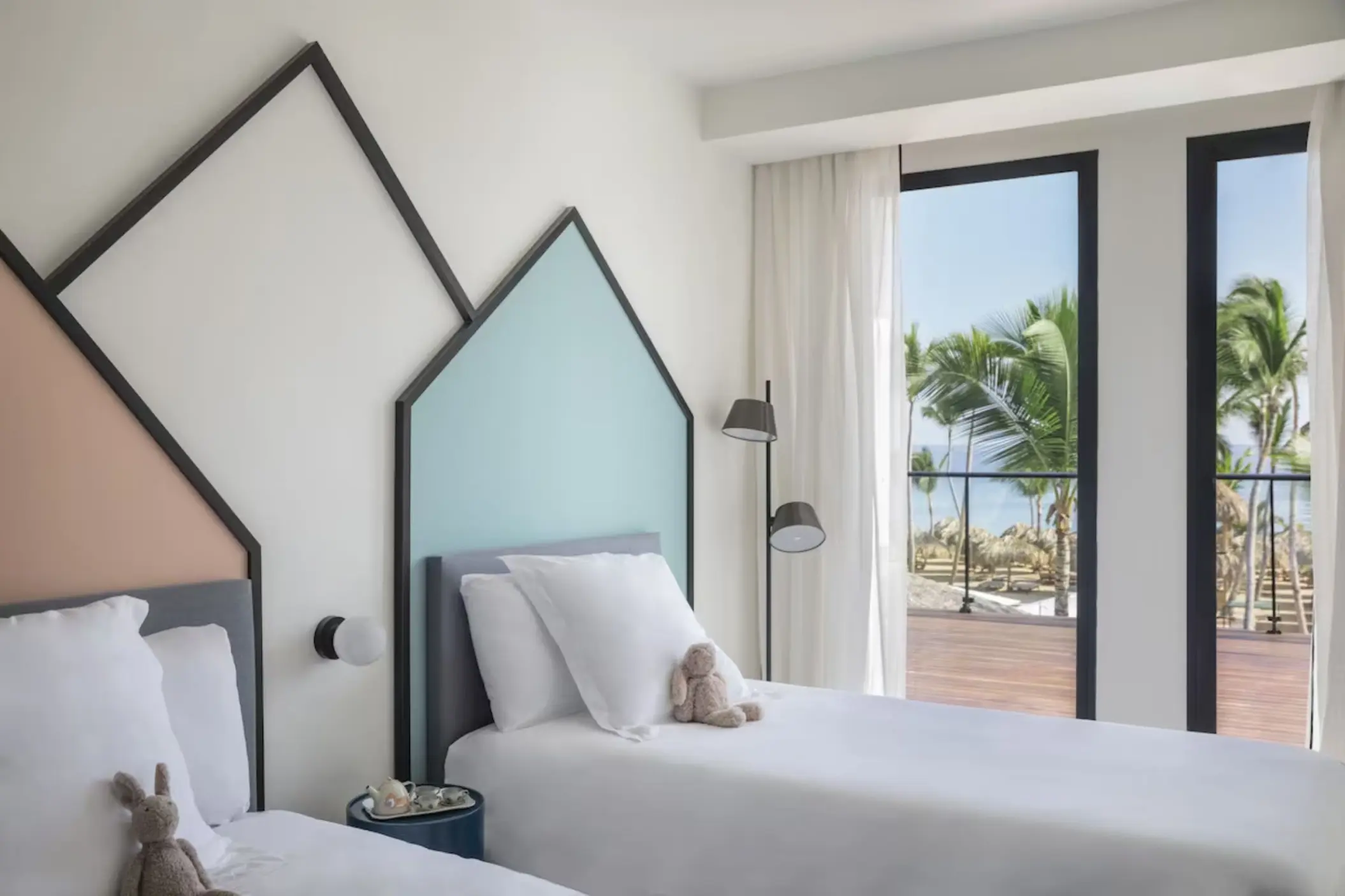 Family suite with twin beds and colorful wall accents at Finest Punta Cana, Punta Cana