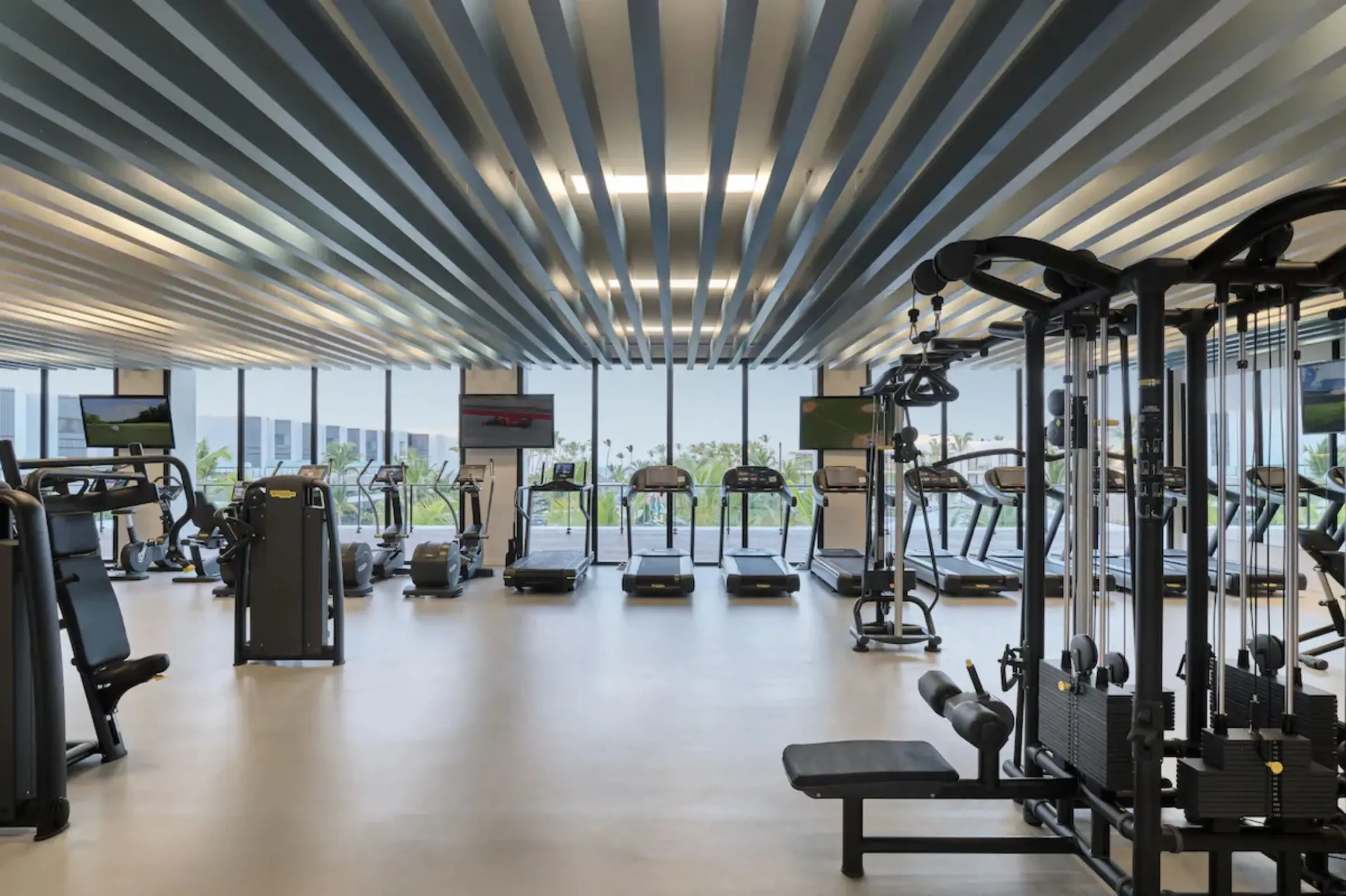 Modern fitness center with treadmills and weight machines at Finest Punta Cana, Punta Cana