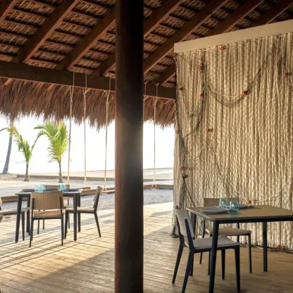 Las Dunas Beachhouse restaurant with thatched roof and ocean views at Finest Punta Cana, Punta Cana