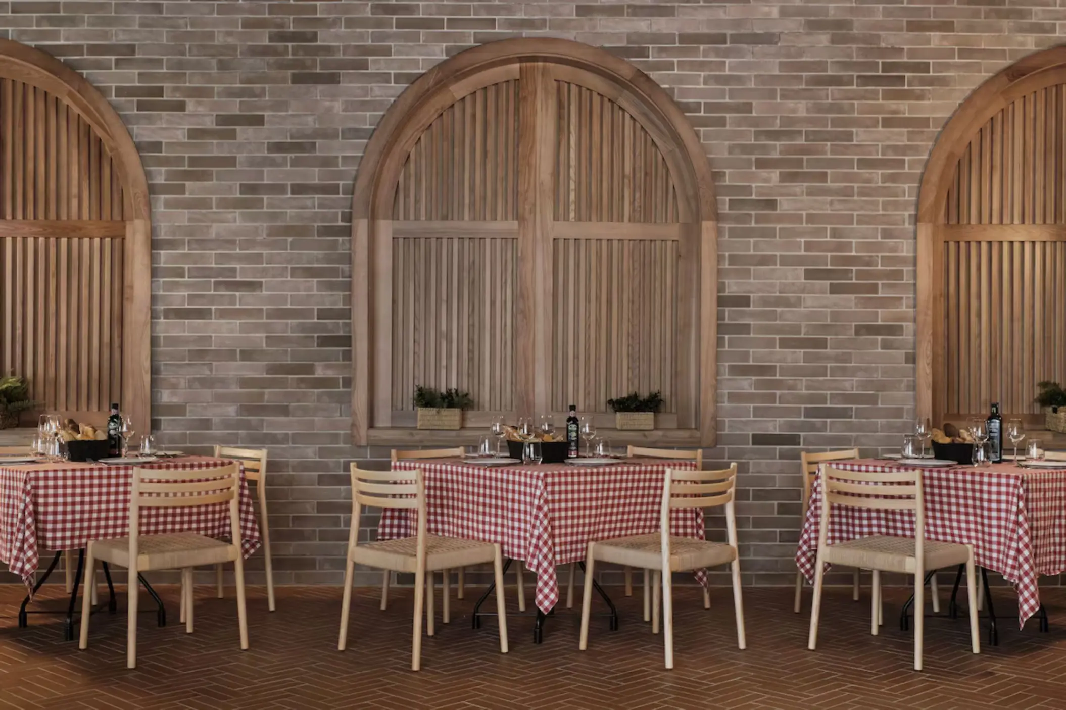 Restaurant with red checkered tablecloths and brick walls at Finest Punta Cana