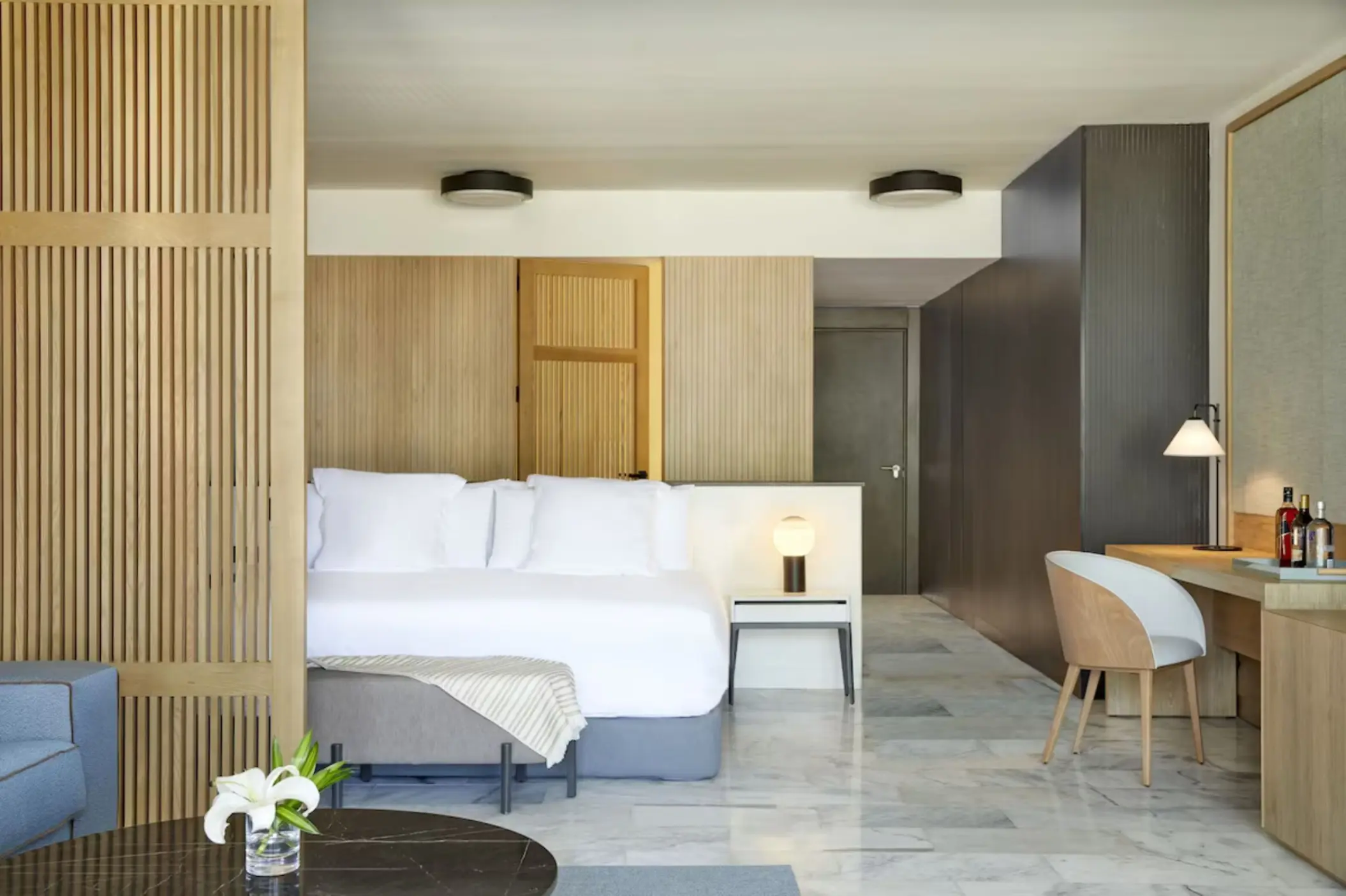 Modern guest suite with light wood accents and white bedding at Finest Punta Cana, Punta Cana