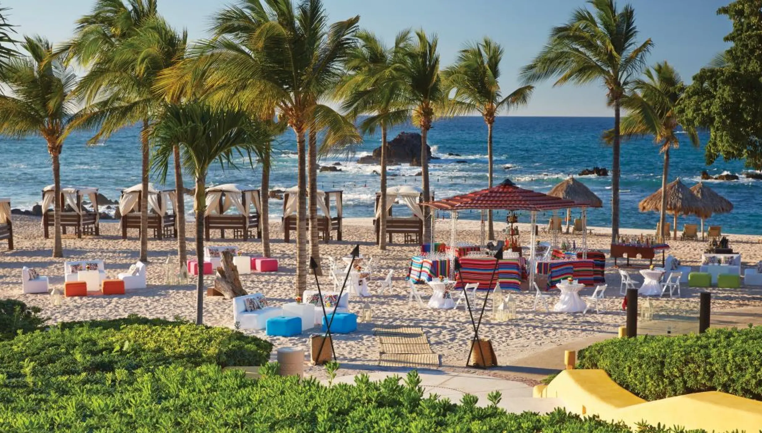 Outdoor wedding reception setup on the sand at Four Seasons Punta Mita