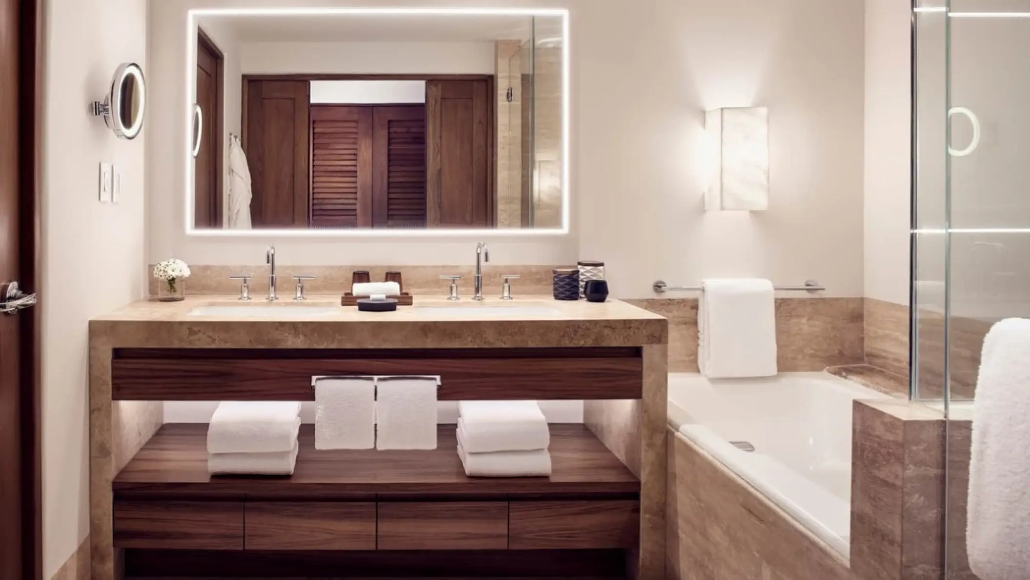 Modern ensuite bathroom with double vanity and soaking tub at Four Seasons Punta Mita