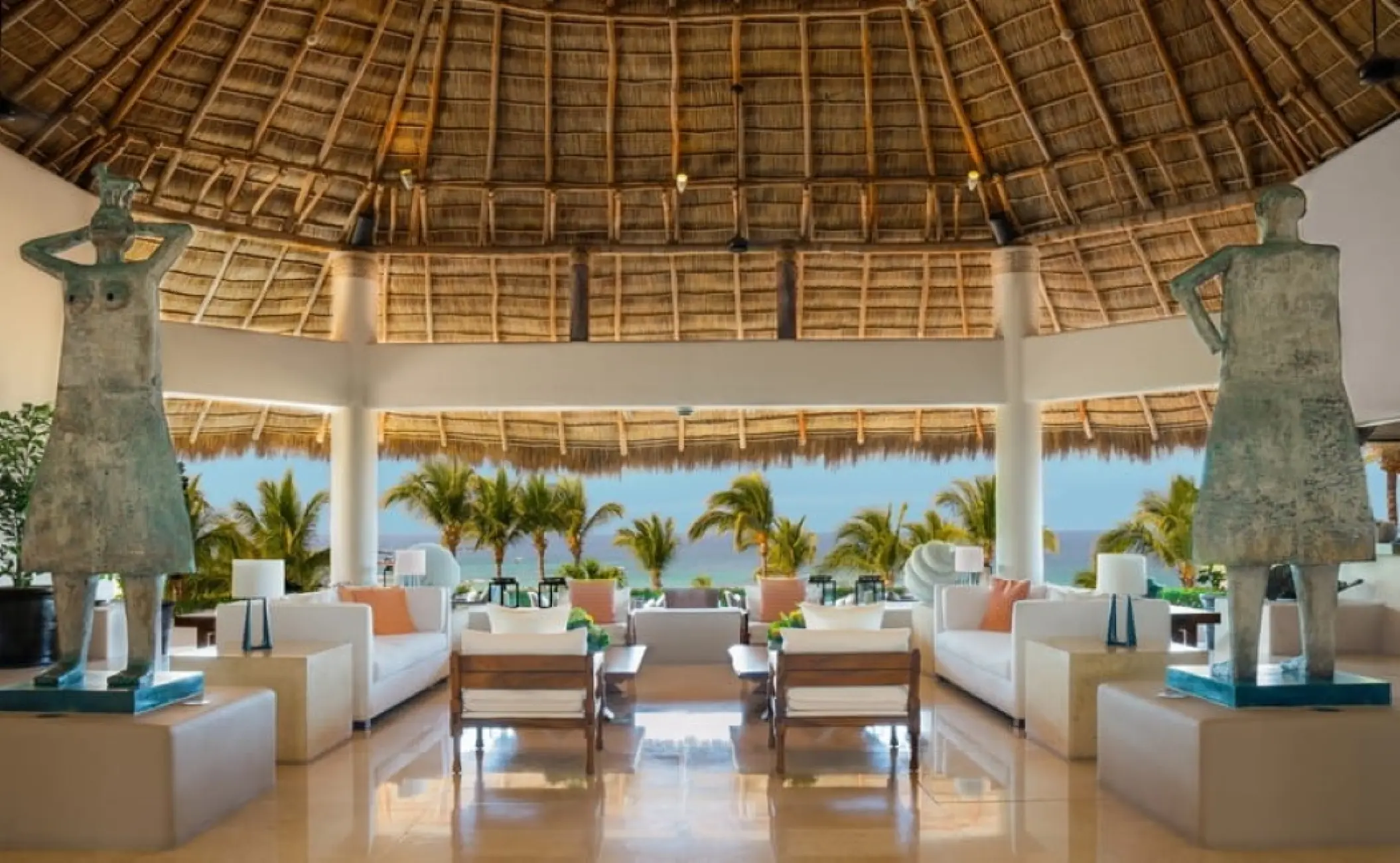 Palapa-style open lobby with sculptures and ocean views at Four Seasons Punta Mita