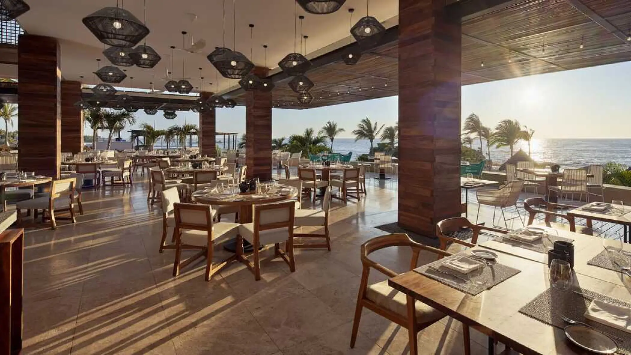 Open-air restaurant overlooking the ocean at sunset at Four Seasons Punta Mita