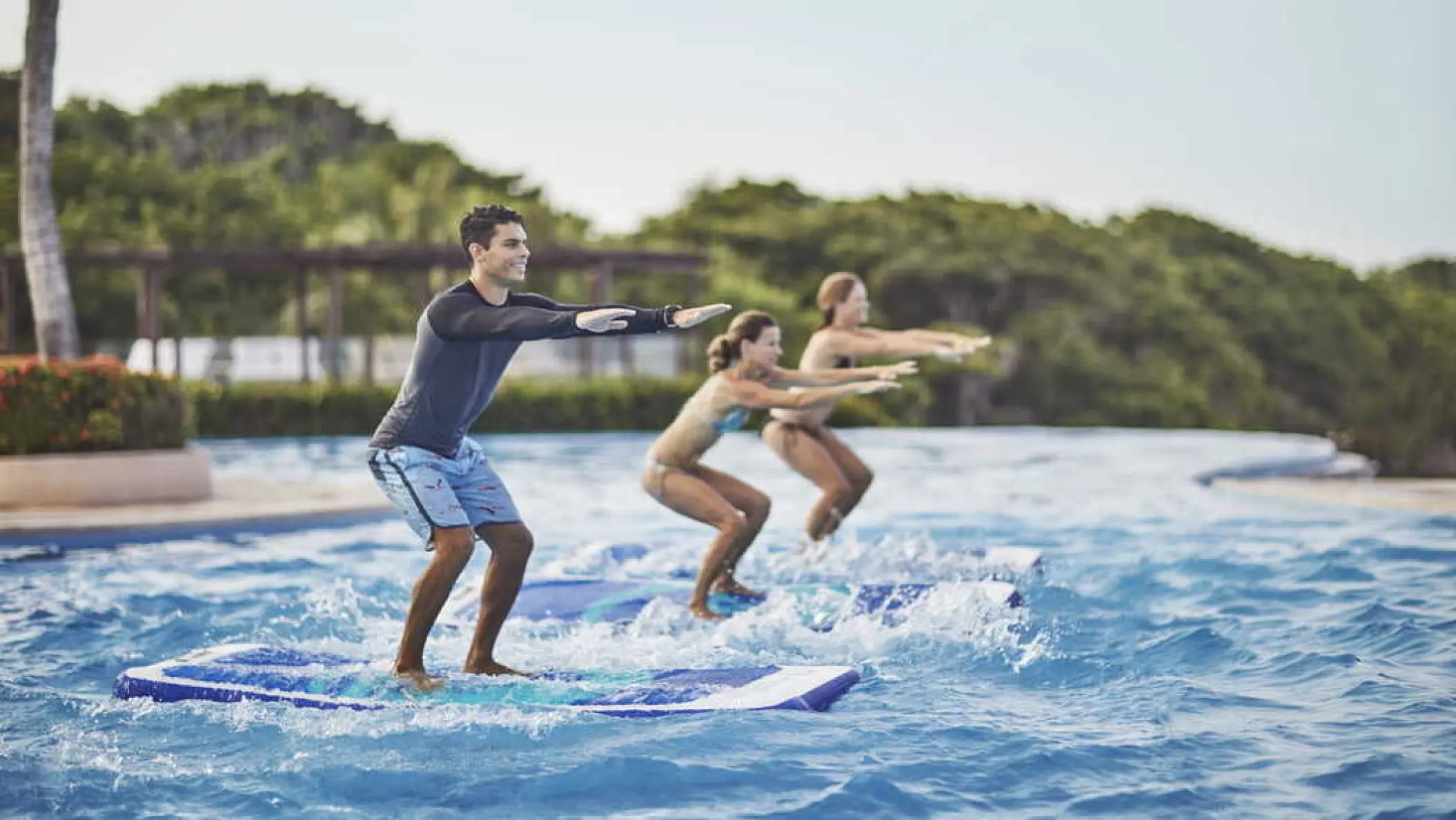 Guests participating in a pool fitness class at Four Seasons Punta Mita