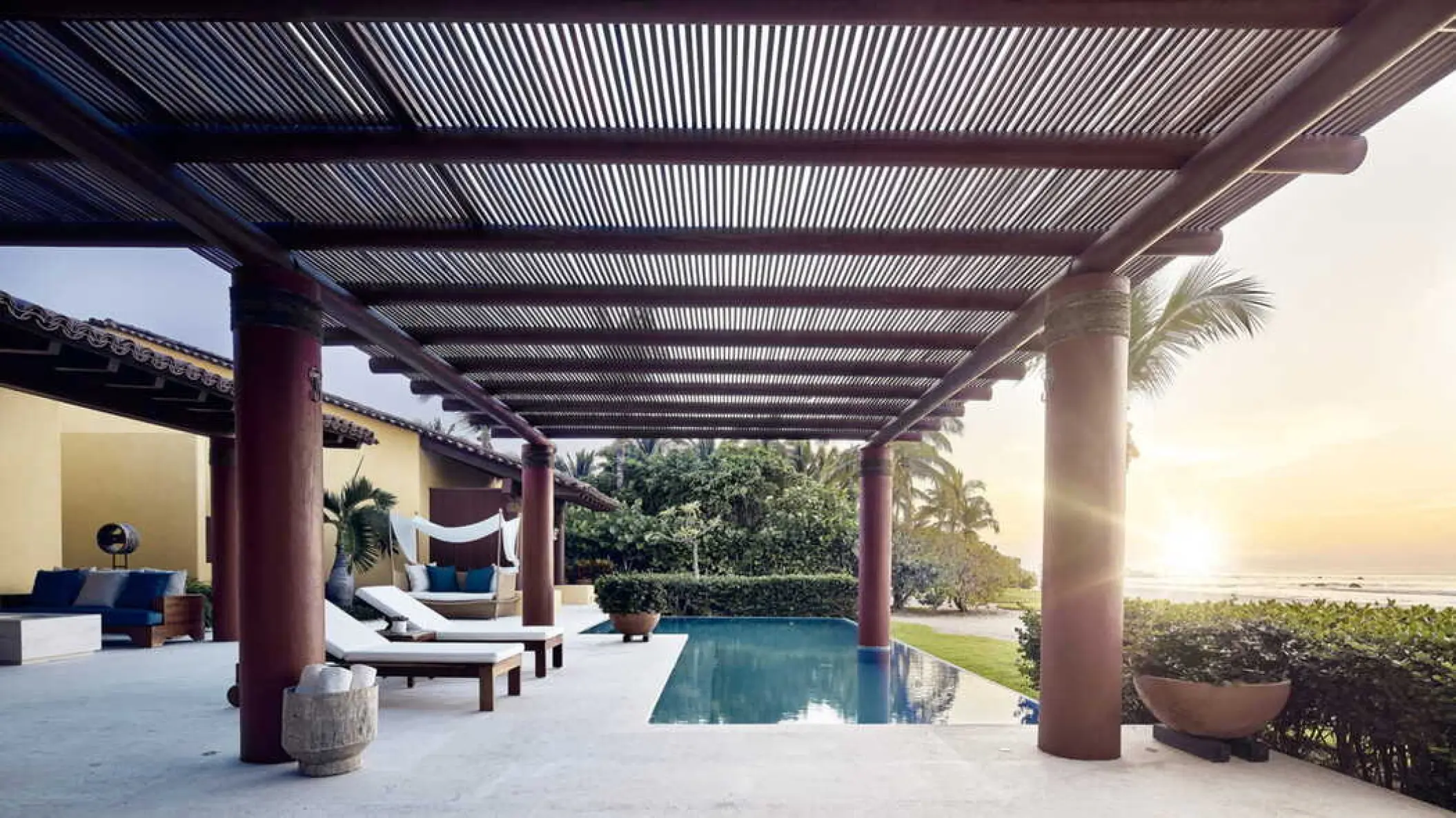 Private pool and terrace under a wooden pergola at sunset at Four Seasons Punta Mita