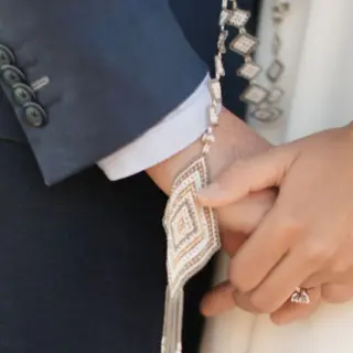 Close up of a couple holding hands with a traditional lasso for a wedding ceremony at Four Seasons Punta Mita