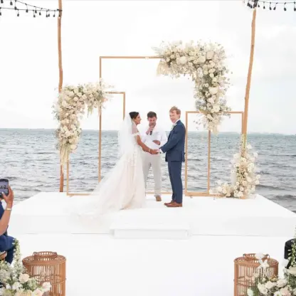 Beachfront wedding ceremony on a white platform at Garza Blanca Cancun