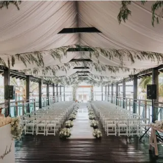 Pier deck wedding ceremony under a draped canopy at Generations Riviera Maya, Riviera Maya