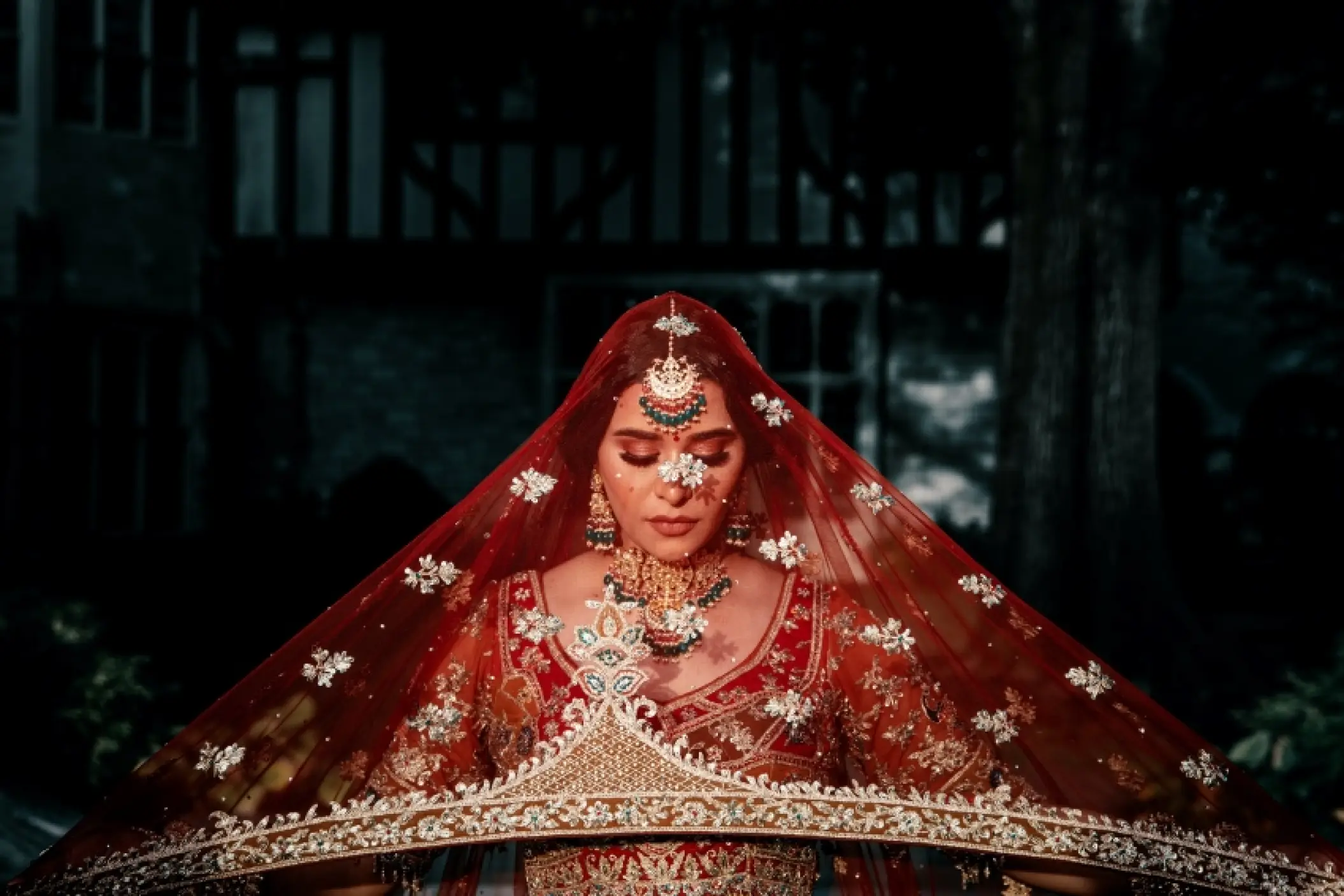 South Asian bride in a red lehenga and traditional jewelry at Grand Bavaro Princess, Punta Cana