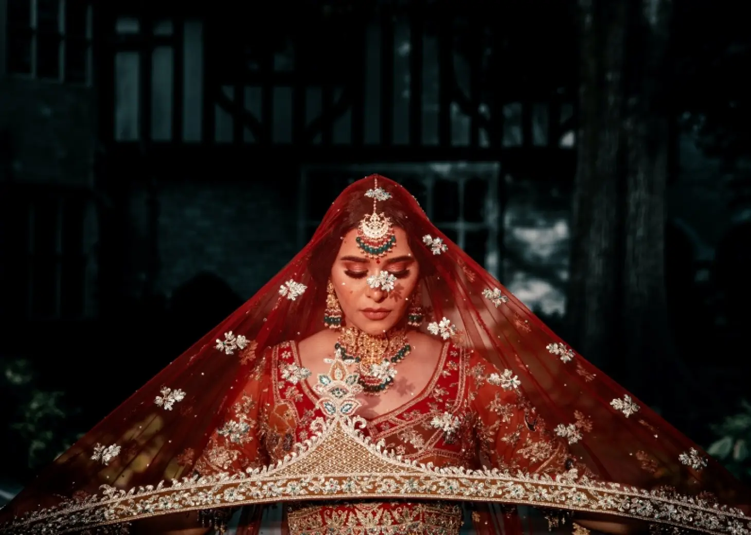 South Asian bride in a red lehenga and traditional jewelry at Grand Bavaro Princess, Punta Cana