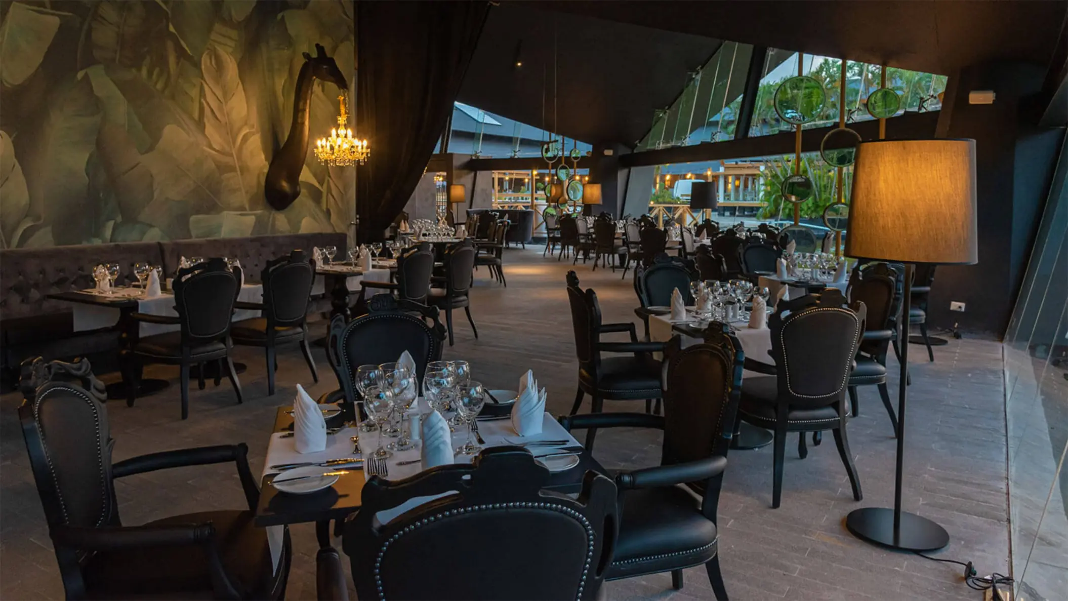Elegant indoor restaurant with black ornate chairs and soft lighting at Grand Bavaro Princess, Punta Cana