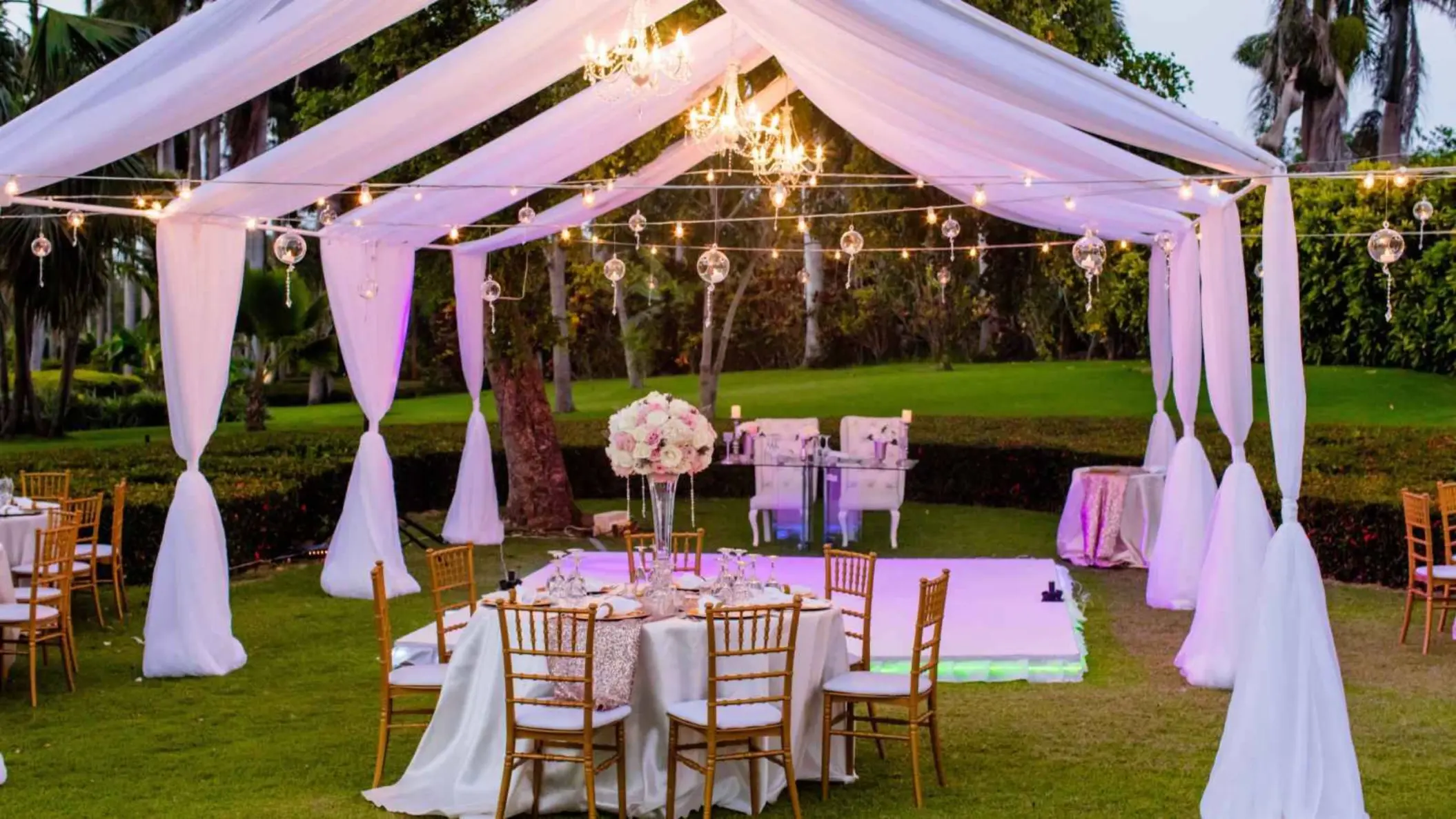 Garden wedding reception under white draping and string lights at Grand Bavaro Princess, Punta Cana