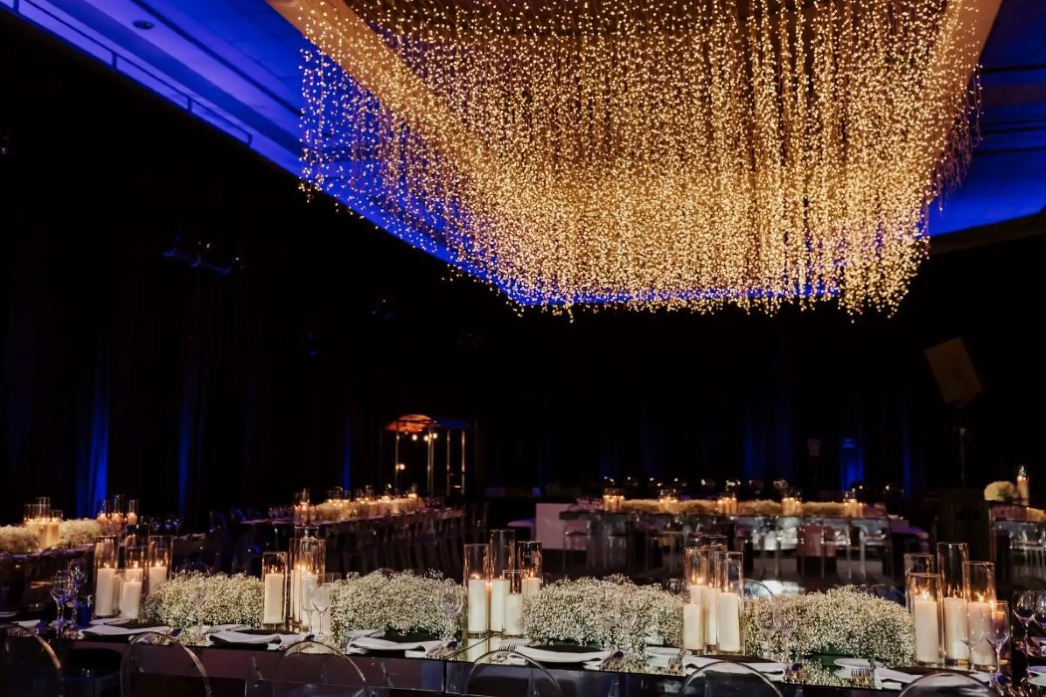 Grand ballroom wedding reception with hanging lights and floral centerpieces at Grand Fiesta Americana Coral Beach, Cancun