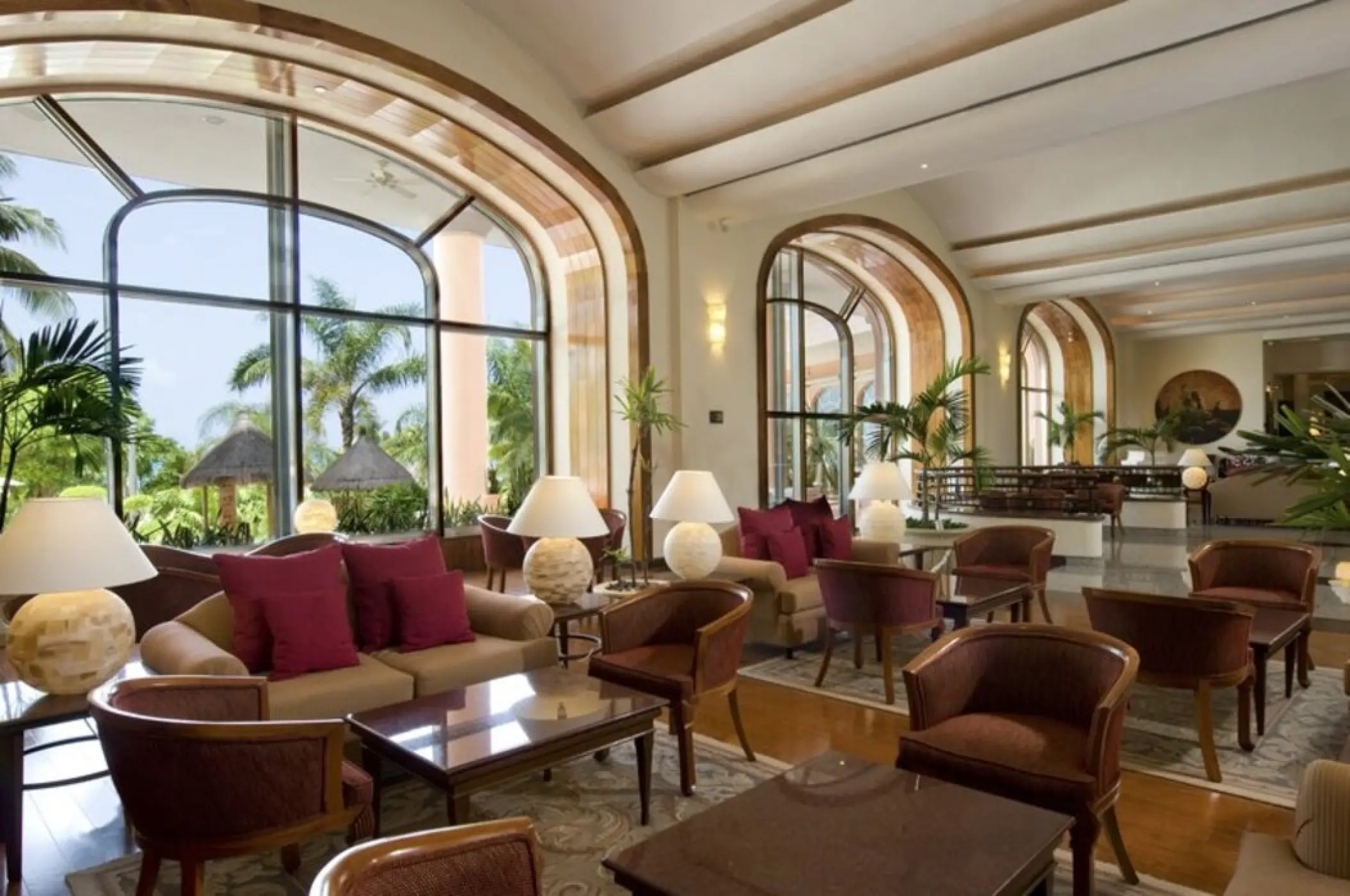 Grand Fiesta Americana Coral Beach lobby lounge with arched windows and palm views, Cancun