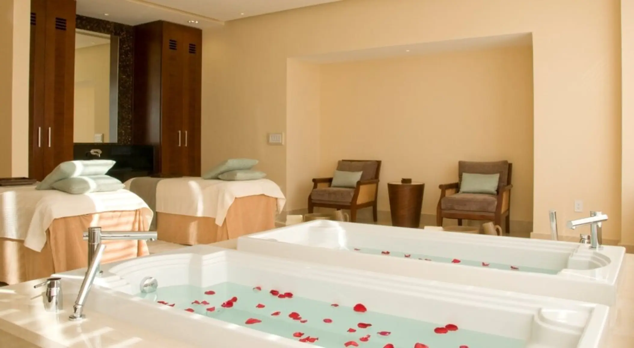 Spa treatment room with flower petal baths and massage tables at Grand Fiesta Americana Coral Beach, Cancun