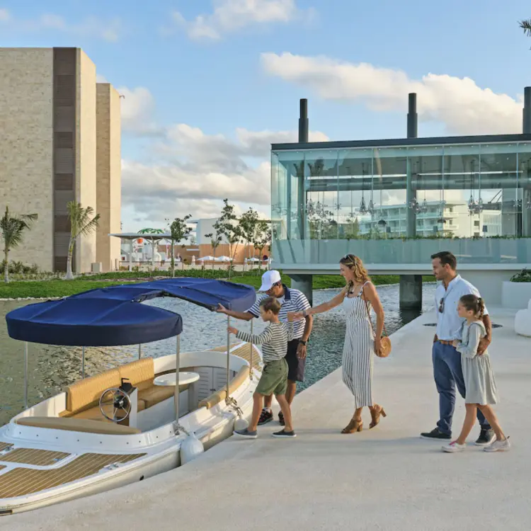 A family boarding a canal boat at Grand Palladium Costa Mujeres, Cancun