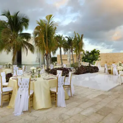 Fizz Pool Terrace wedding reception with white chairs and dance floor at Grand Palladium Costa Mujeres, Cancun
