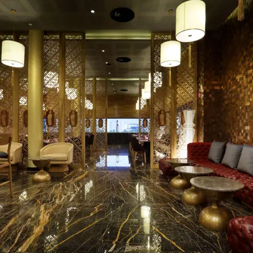 Modern restaurant interior with marble floors and wooden partitions at Grand Palladium Costa Mujeres, Cancun