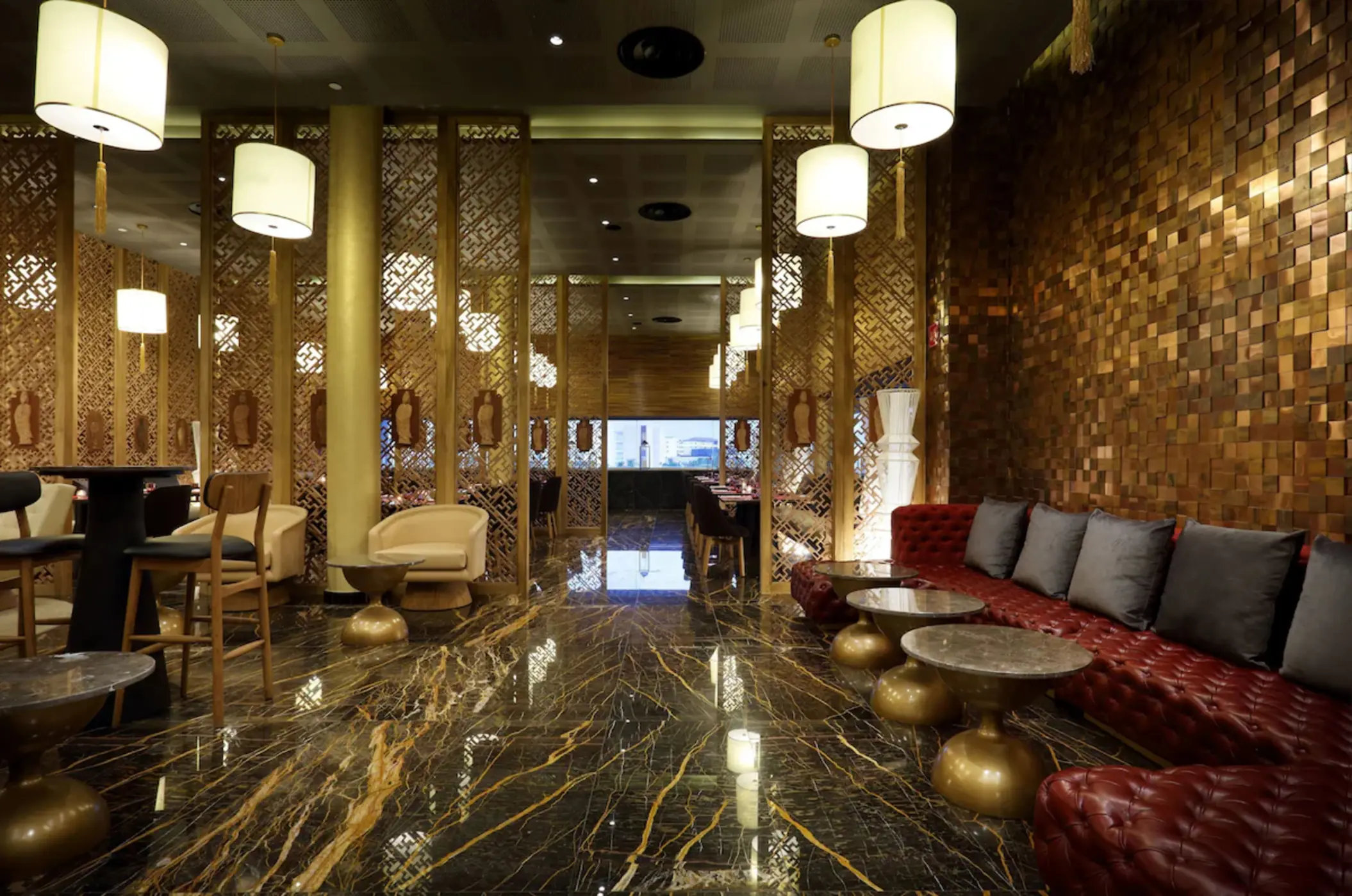 Modern restaurant interior with marble floors and wooden partitions at Grand Palladium Costa Mujeres, Cancun