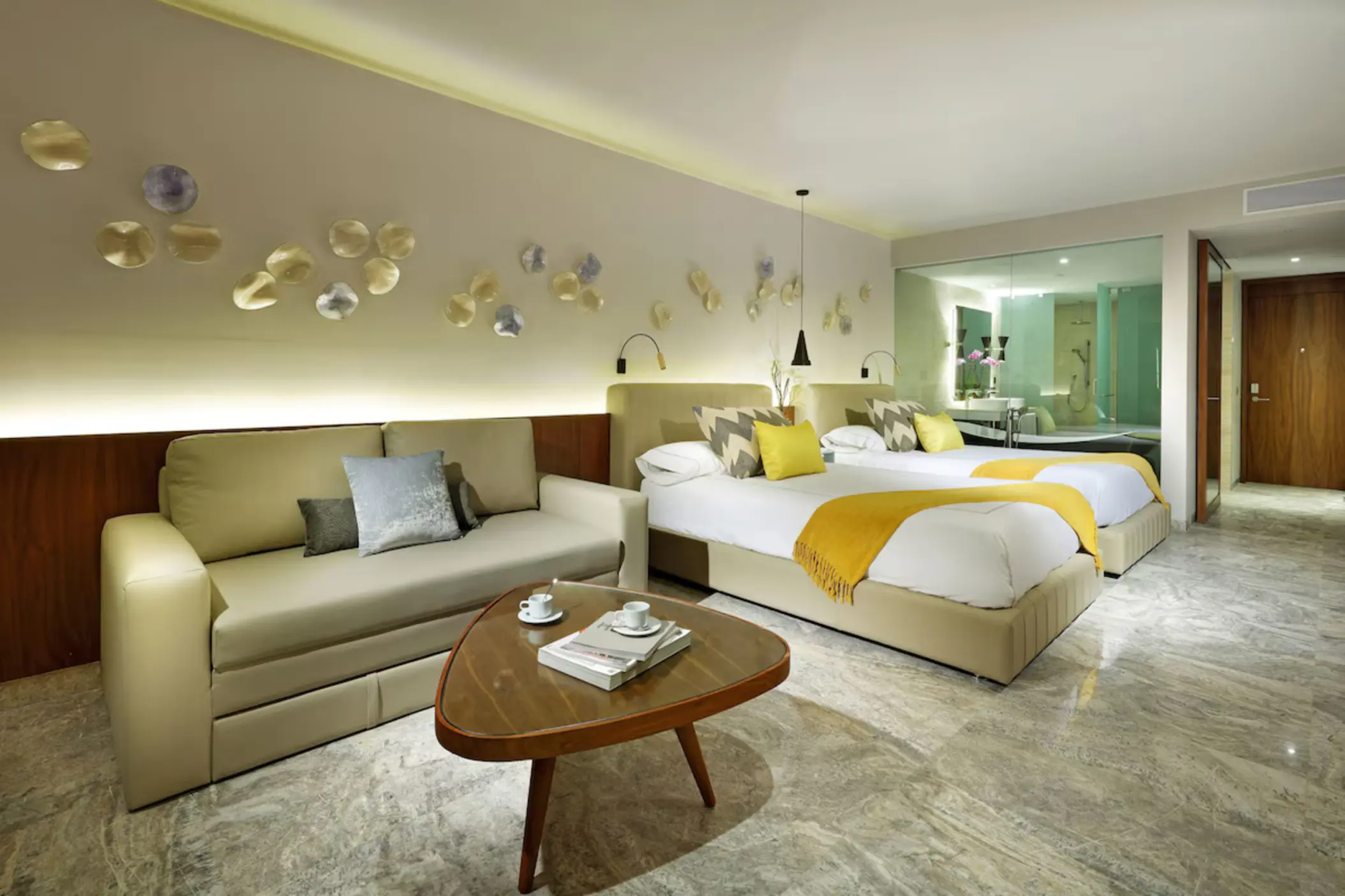 Modern suite with two double beds and a lounge area at Grand Palladium Costa Mujeres, Cancun