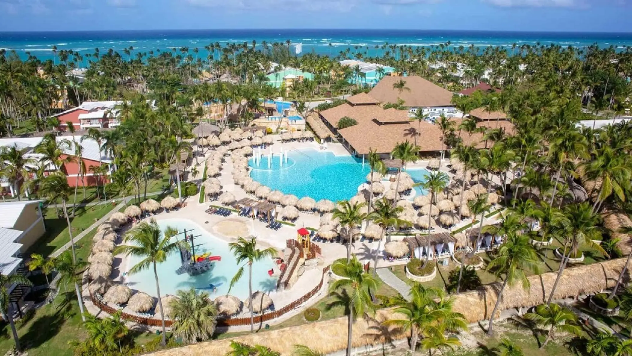 Aerial view of swimming pools and palm trees at Grand Palladium Punta Cana, Punta Cana